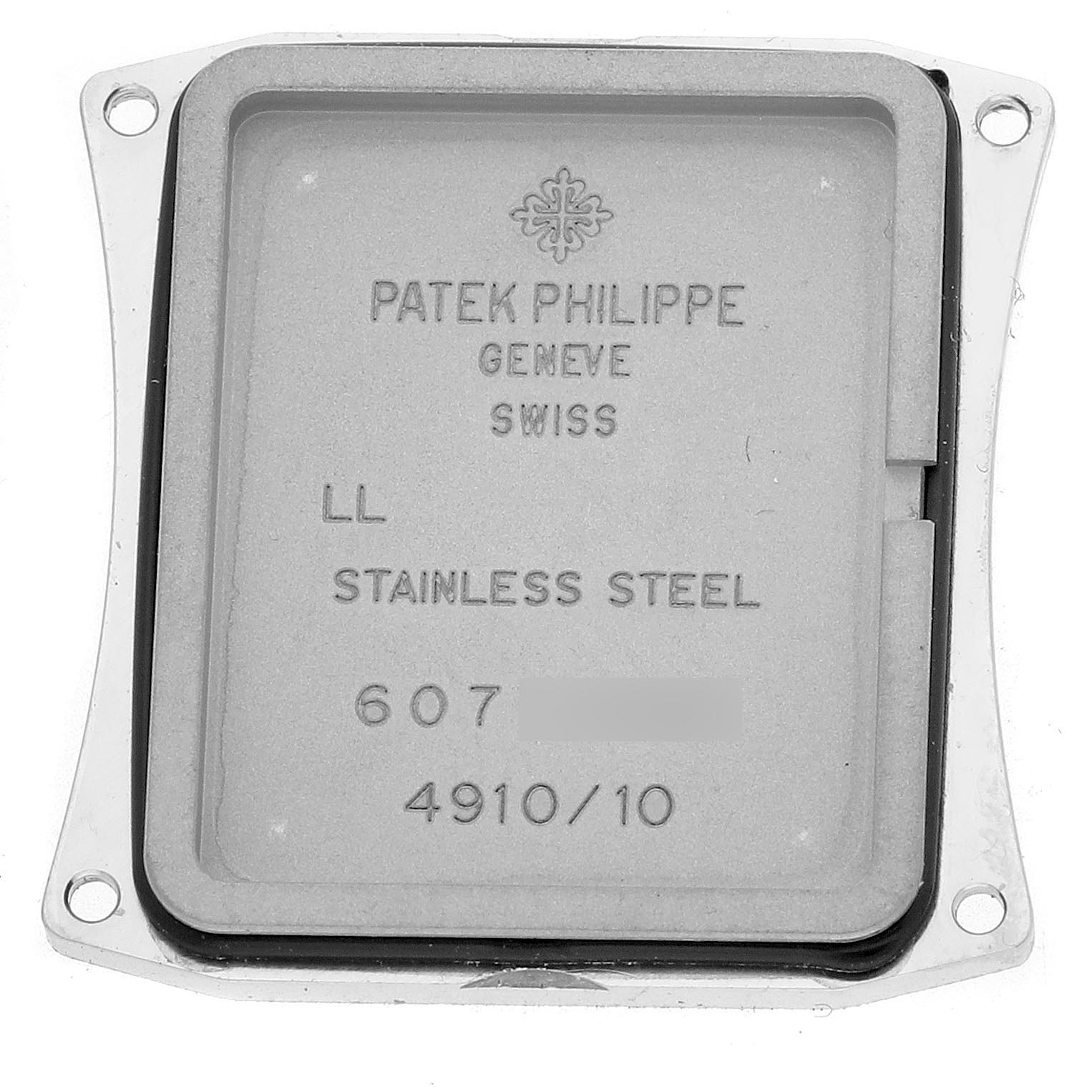 The image shows the back cover of a Patek Philippe Twenty-4 4910/10A Women's Stainless Steel Silver Dial 4910/10A Women's Stainless Steel Silver Dial watch, featuring engravings and screw holes.