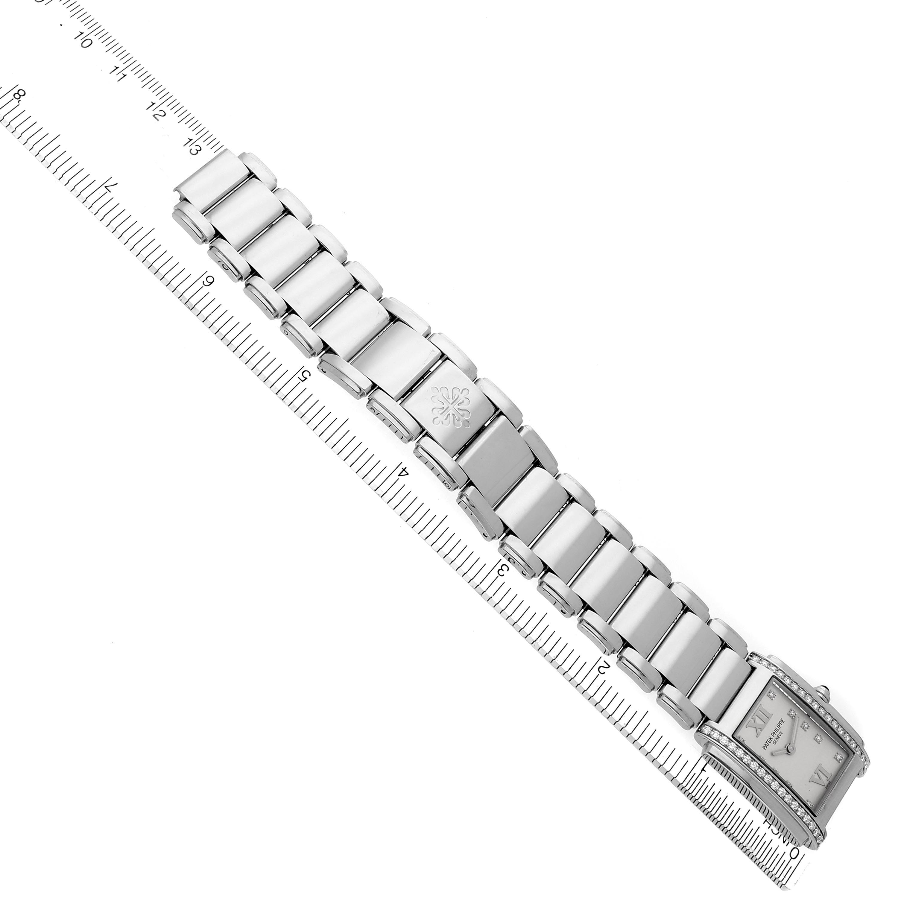 The Patek Philippe Twenty-4 4910/10A Women's Stainless Steel Silver Dial 4910/10A Women's Stainless Steel Silver Dial watch is shown from an overhead angle, displaying the bracelet and face, with a ruler beside it.