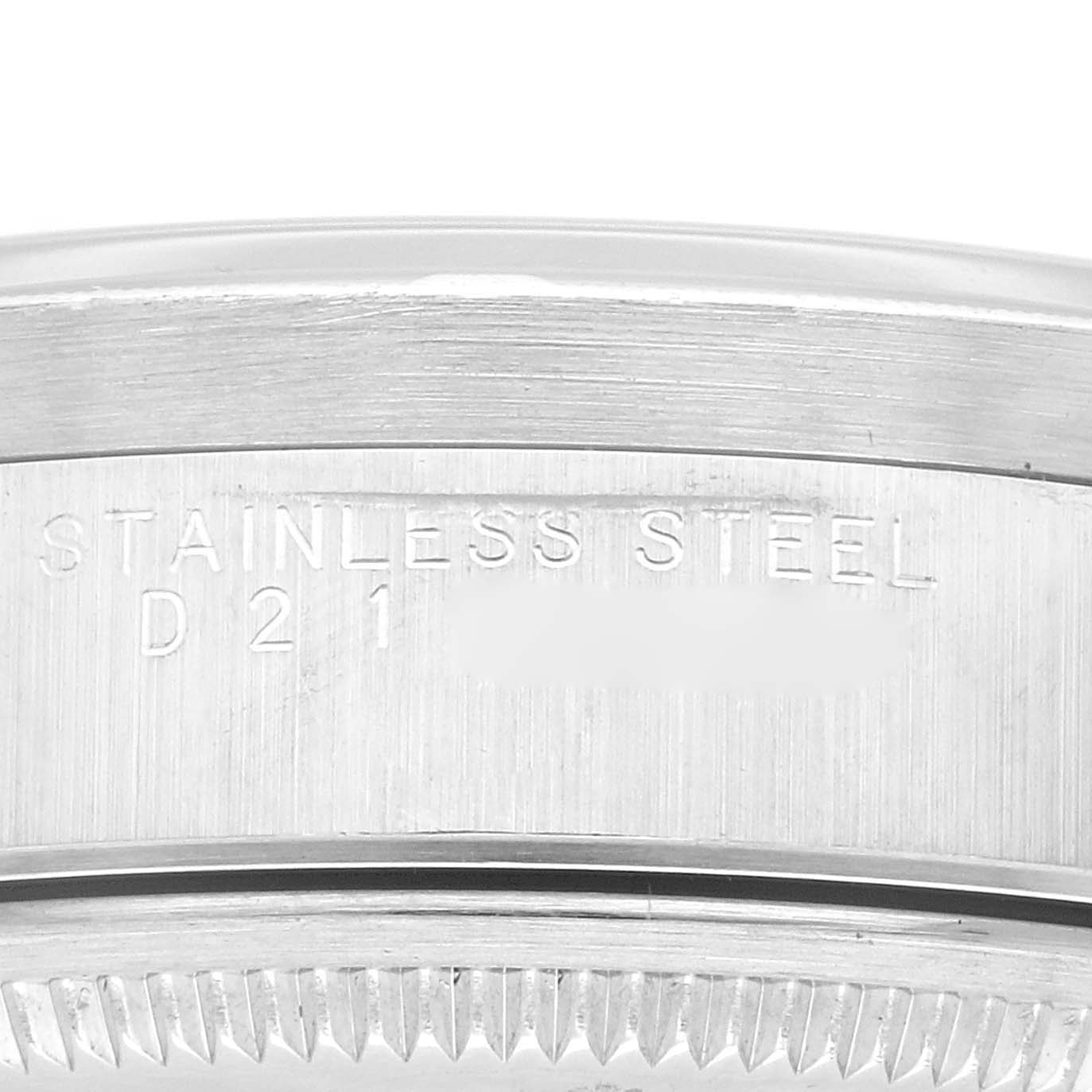 This close-up angle shows the side of the Rolex Air-King 14010 Men's Stainless Steel Pink Dial 14010 Men's Stainless Steel Pink Dial watch case with "STAINLESS STEEL" engraved on it.