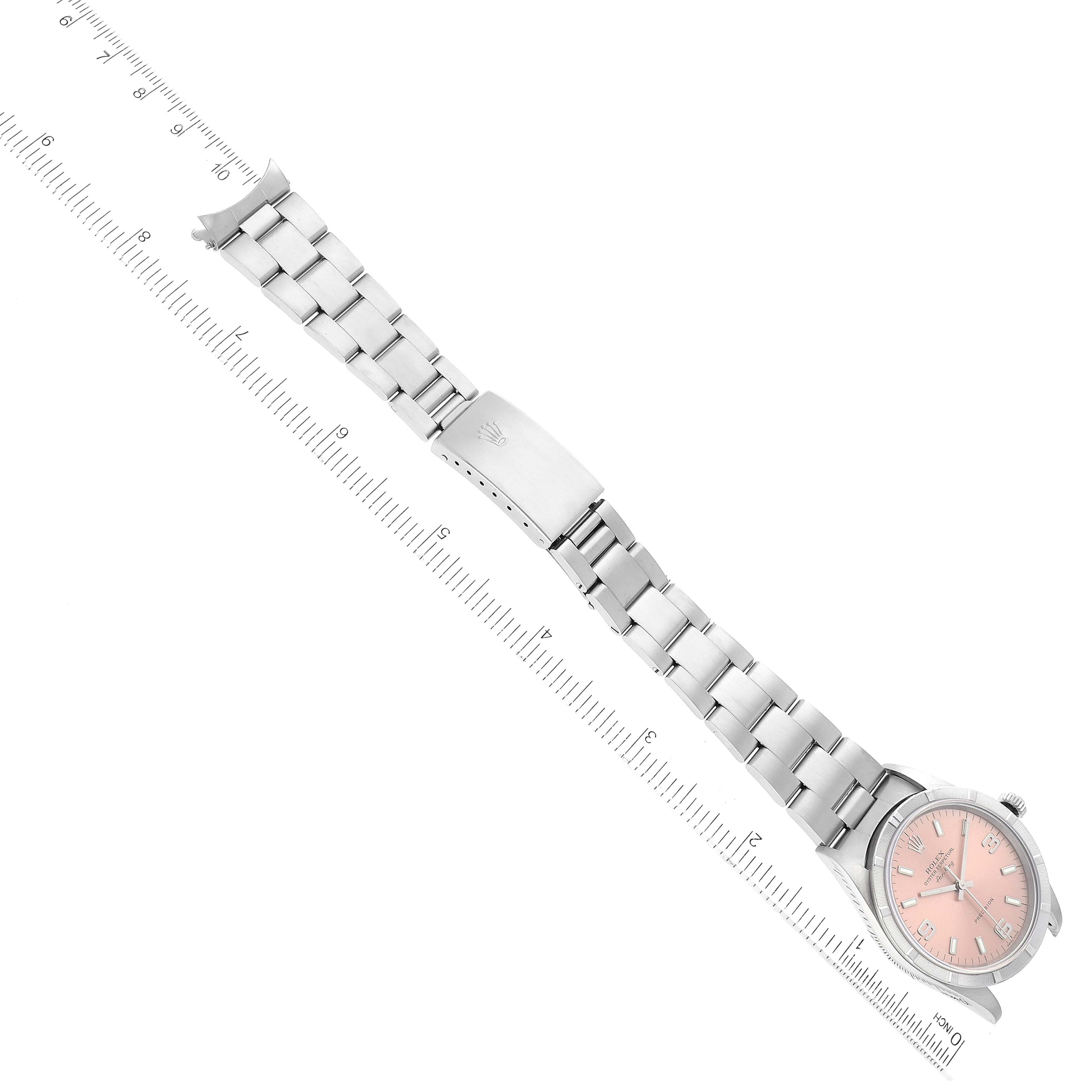 This image shows a Rolex Air-King 14010 Men's Stainless Steel Pink Dial 14010 Men's Stainless Steel Pink Dial watch laid flat, displaying its bracelet, clasp, and face from a top-down angle alongside a ruler.