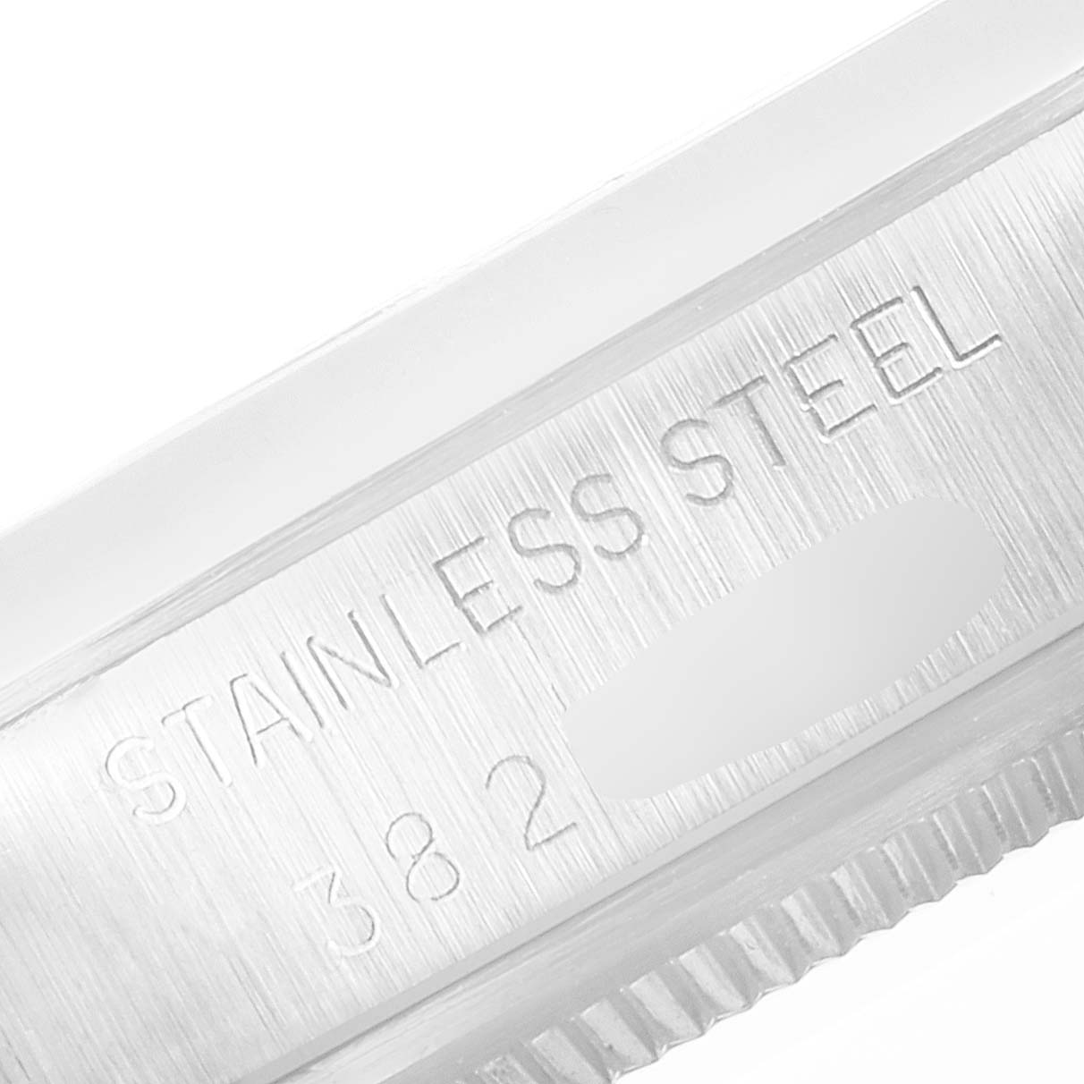 This close-up image shows the stainless steel engravings on the side of the Rolex Vintage Collection 5700 Men's Stainless Steel Silver Dial 5700 Men's Stainless Steel Silver Dial model.