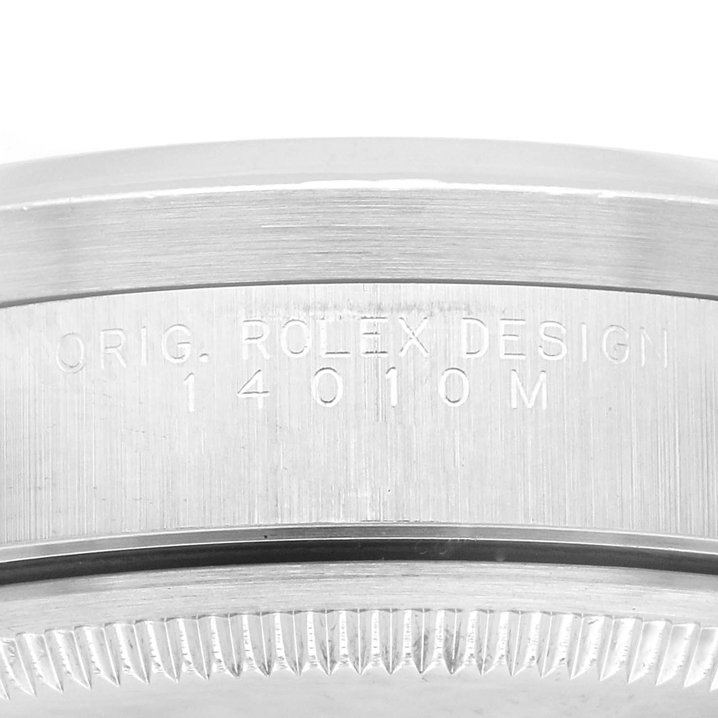 The image shows a close-up of the side of a Rolex Air-King 14010 Men's Stainless Steel Silver Dial 14010 Men's Stainless Steel Silver Dial watch case with "ORIG. ROLEX DESIGN 14010M" engraved.