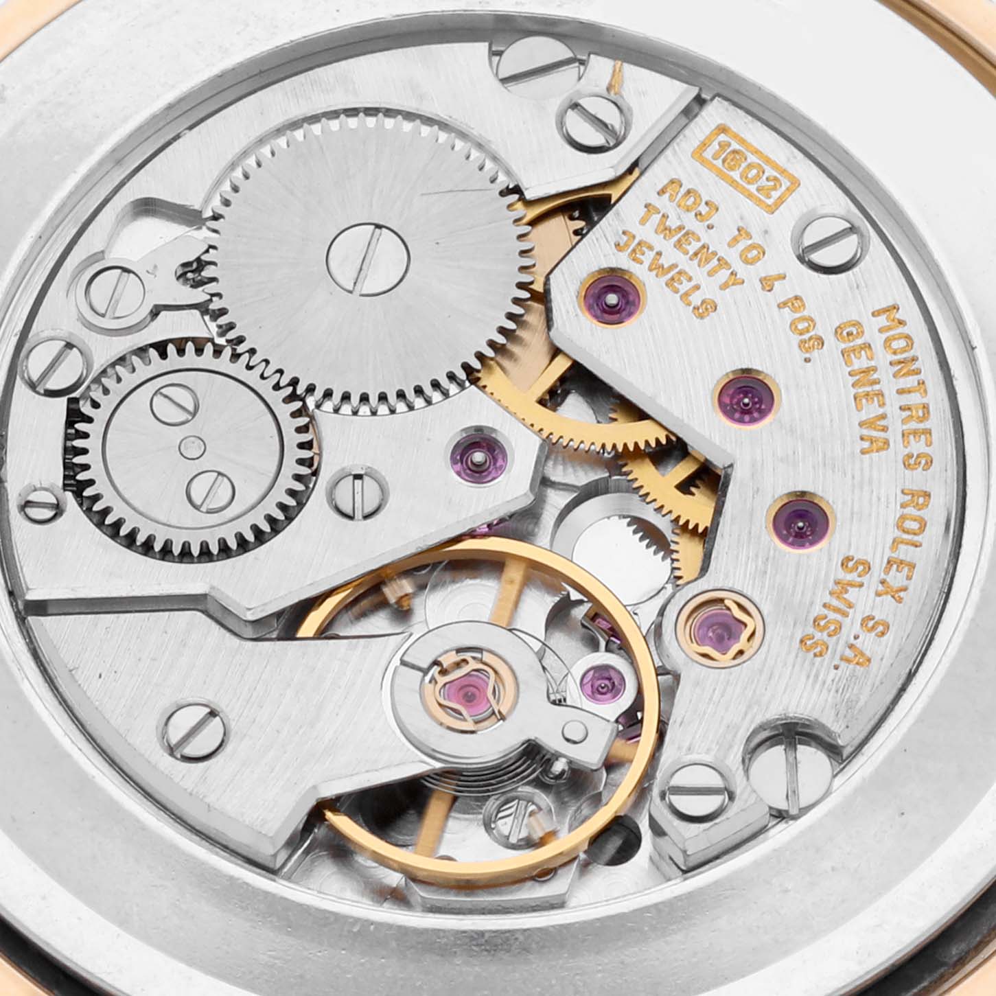 The image shows a close-up of the Rolex Cellini 4112 Men's Yellow Gold Grey Dial 4112 Men's Yellow Gold Grey Dial watch movement, highlighting gears and jewels from a top-down angle.