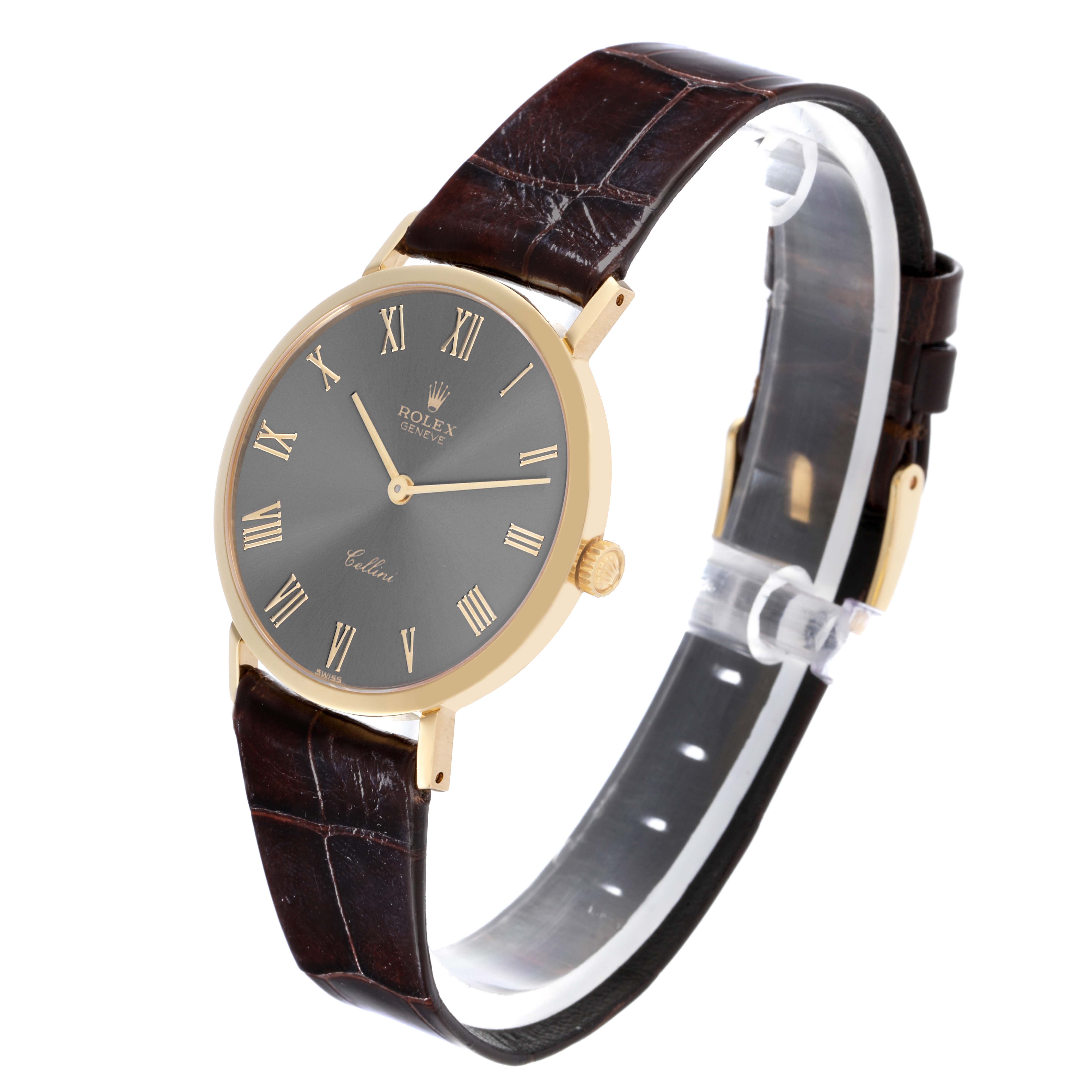 The Rolex Cellini 4112 Men's Yellow Gold Grey Dial 4112 Men's Yellow Gold Grey Dial watch is shown from a three-quarter view, highlighting the dial, crown, and leather strap.