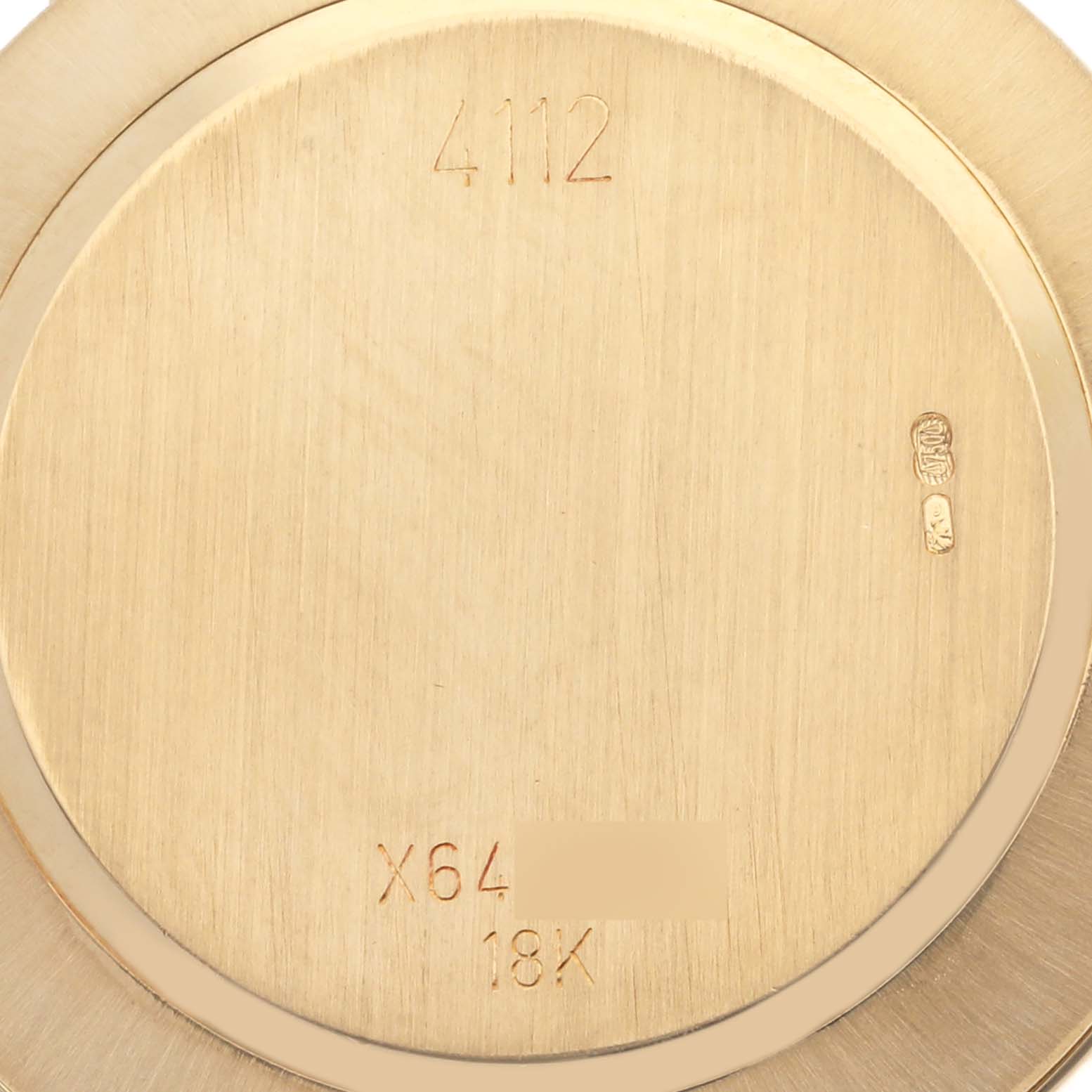 The image shows the back case of a Rolex Cellini 4112 Men's Yellow Gold Grey Dial 4112 Men's Yellow Gold Grey Dial watch, displaying engraved numbers and hallmarks.