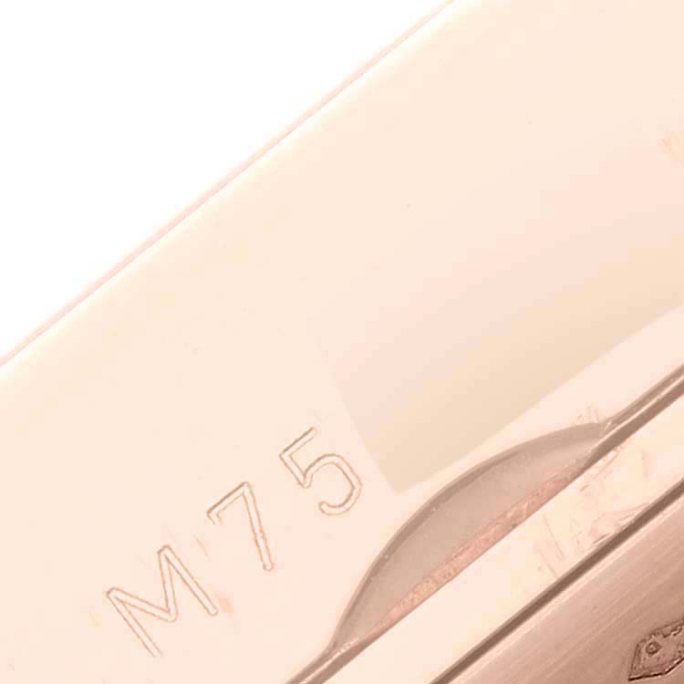 This close-up image shows the side of a polished metal case of a Rolex Cellini 5442/5 Men's Rose Gold Black Dial 5442/5 Men's Rose Gold Black Dial watch, highlighting the engraved "M75."