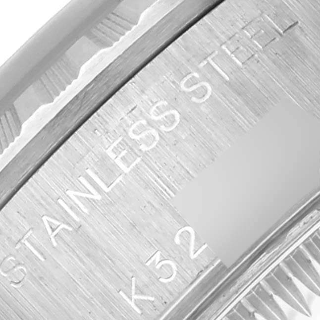The image shows a close-up of the case edge engraving on the Rolex Date 79240 Women's Stainless Steel Blue Dial 79240 Women's Stainless Steel Blue Dial model, highlighting "Stainless Steel."
