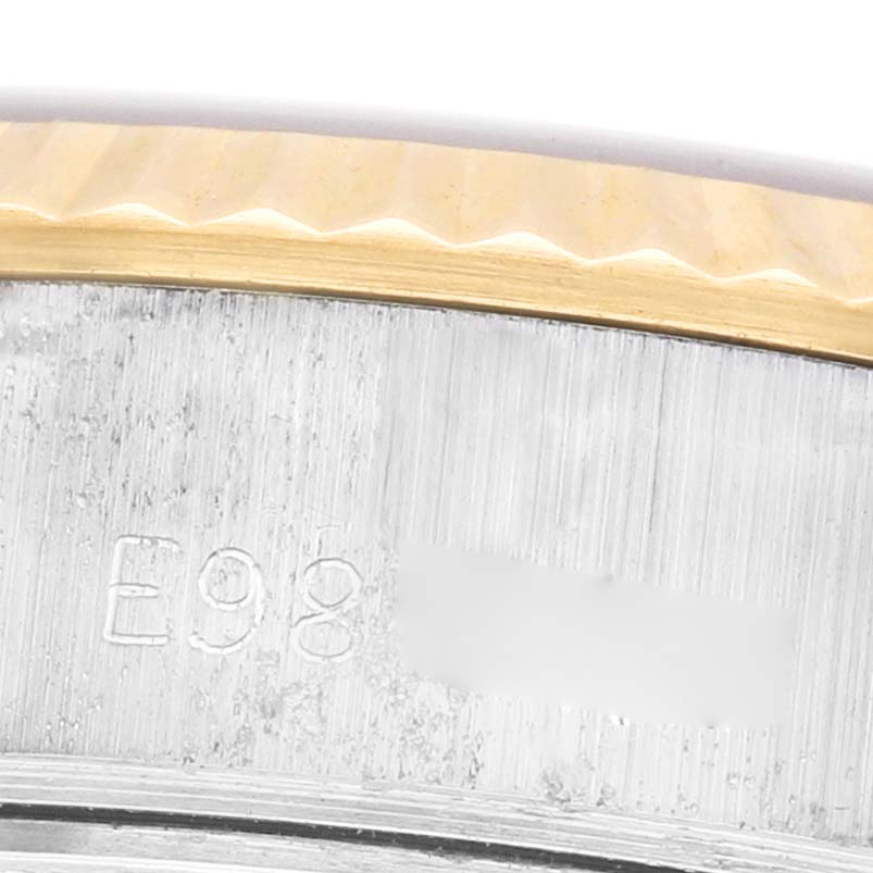 The image shows a close-up of the serial number engraving on the side of the Rolex Datejust 69173 Women's Steel and Gold (two tone) Champagne Dial's case near the bezel.
