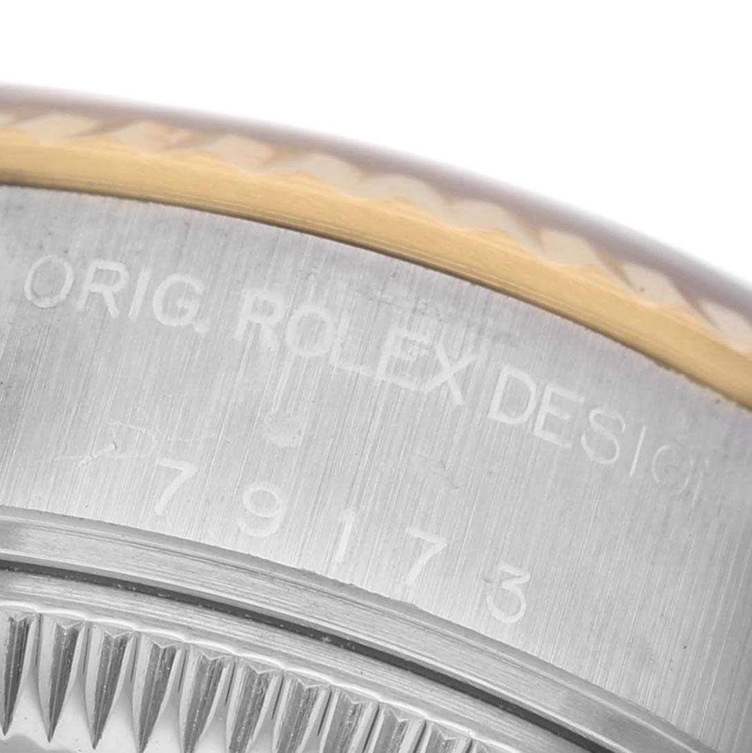 The image shows a close-up of the Rolex Datejust 79173 Women's Steel and Gold (two tone) Silver Dial's case side, highlighting the engraved serial number and bezel detail.