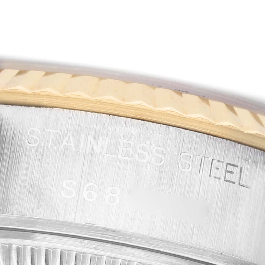 The image shows a close-up of the side of a Rolex Datejust 69173 Women's Steel and Gold (two tone) Silver Dial, highlighting the stainless steel casing and part of the fluted bezel.