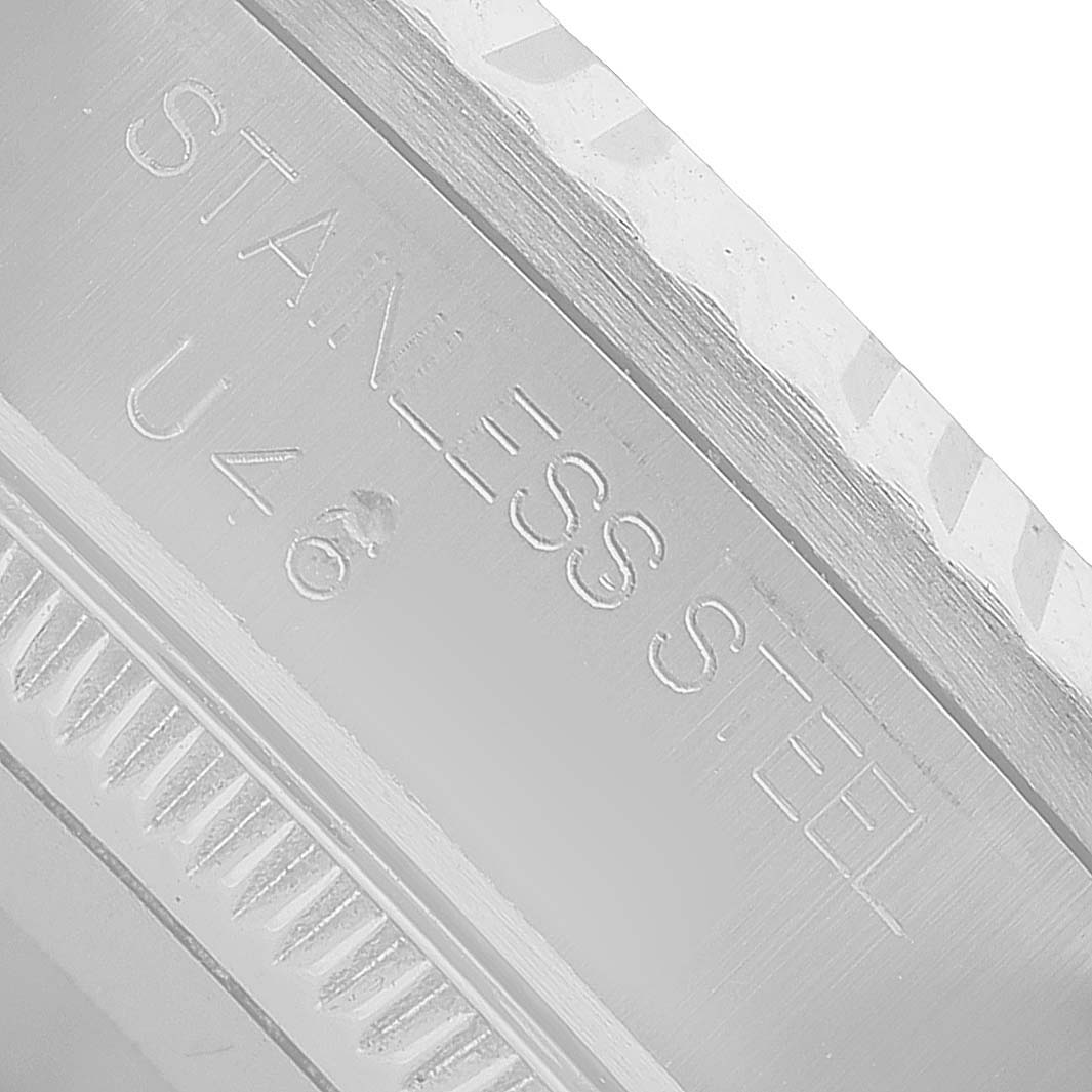 The image shows a close-up of the bezel or case back edge of a Rolex Mid-Size 68274G Women's Steel and Gold (two tone) Silver Dial watch, displaying "STAINLESS STEEL."