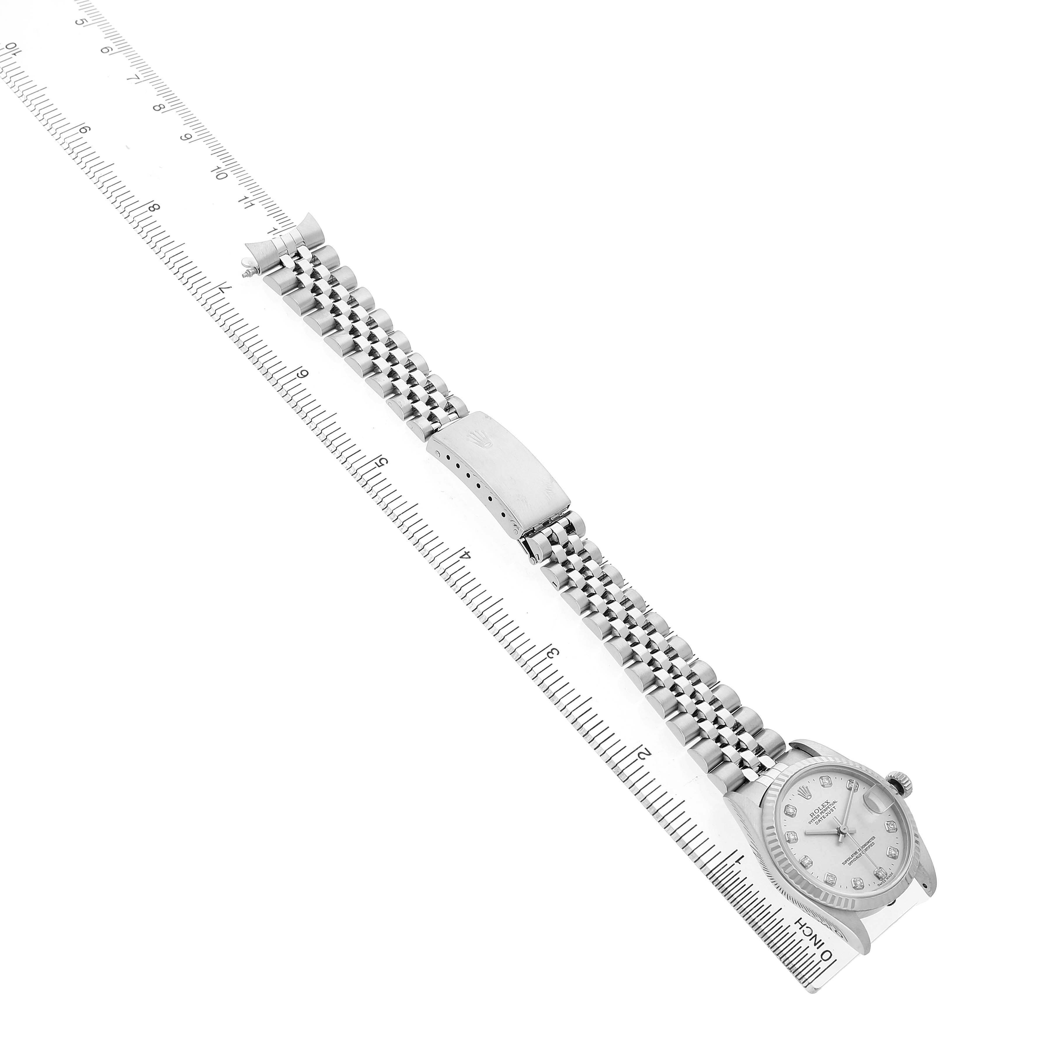 The image shows a side view of the Rolex Mid-Size 68274G Women's Steel and Gold (two tone) Silver Dial watch with its bracelet fully extended, next to a ruler.