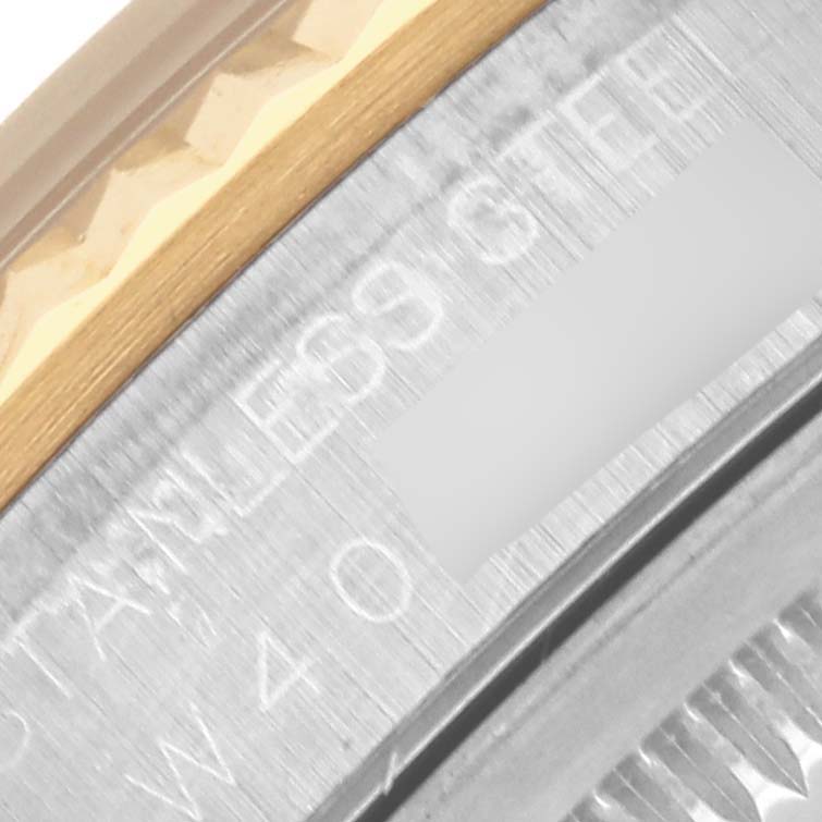 The image shows a close-up of the Rolex Datejust 16233 Men's Steel and Gold (two tone) Blue Dial 16233 Men's Steel and Gold (two tone) Blue Dial's side, focusing on the bezel and part of the engraved case.