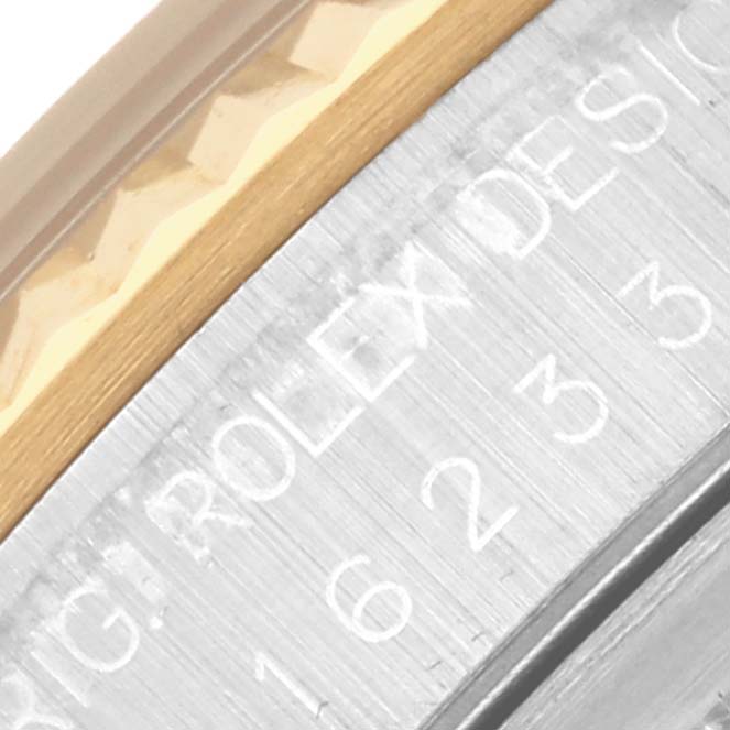 The image shows a close-up of a Rolex Datejust 16233 Men's Steel and Gold (two tone) Blue Dial 16233 Men's Steel and Gold (two tone) Blue Dial, highlighting the engraved bezel edge and serial number.