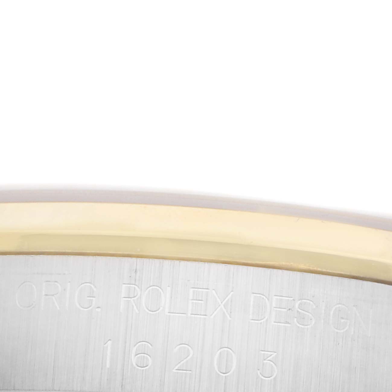 The image shows a close-up of the Rolex Datejust 16203 Men's Steel and Gold (two tone) Champagne Dial 16203 Men's Steel and Gold (two tone) Champagne Dial bezel and case with engraved design details.