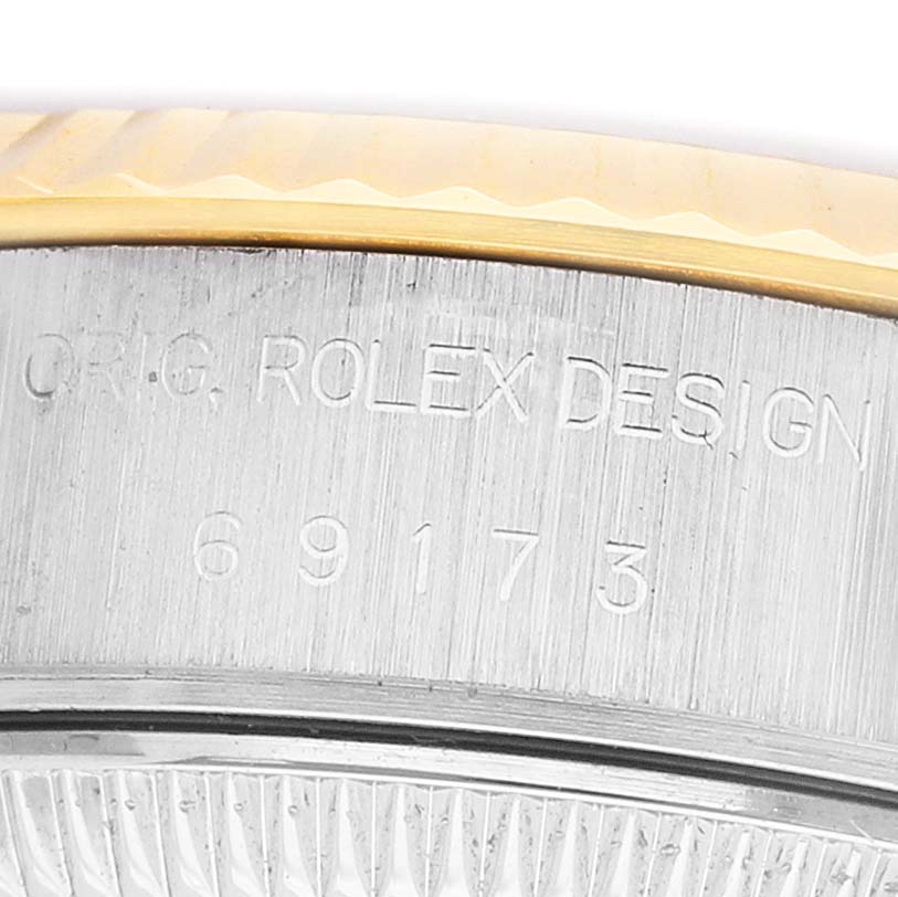 The image shows a close-up of the side of a Rolex Datejust 69173 Women's Steel and Gold (two tone) Champagne Dial, highlighting the engraved trademark and model number.
