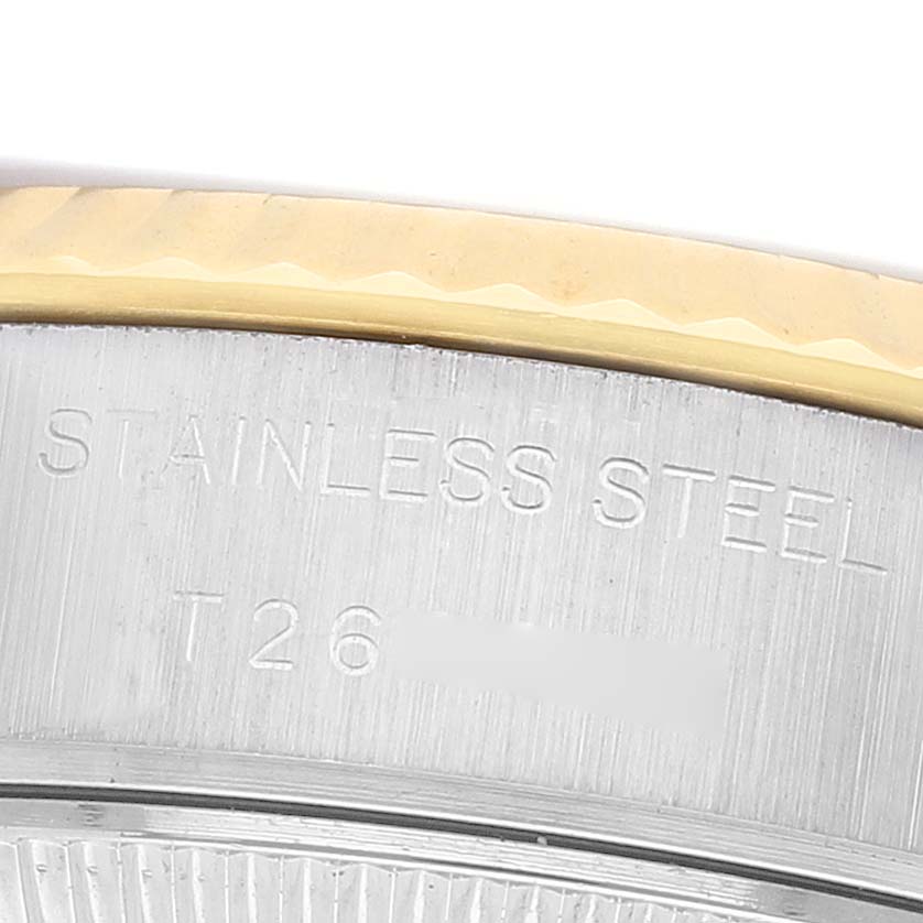 The image shows a close-up of the side of a Rolex Datejust 69173 Women's Steel and Gold (two tone) Champagne Dial watch, highlighting the stainless steel material and engraved details.