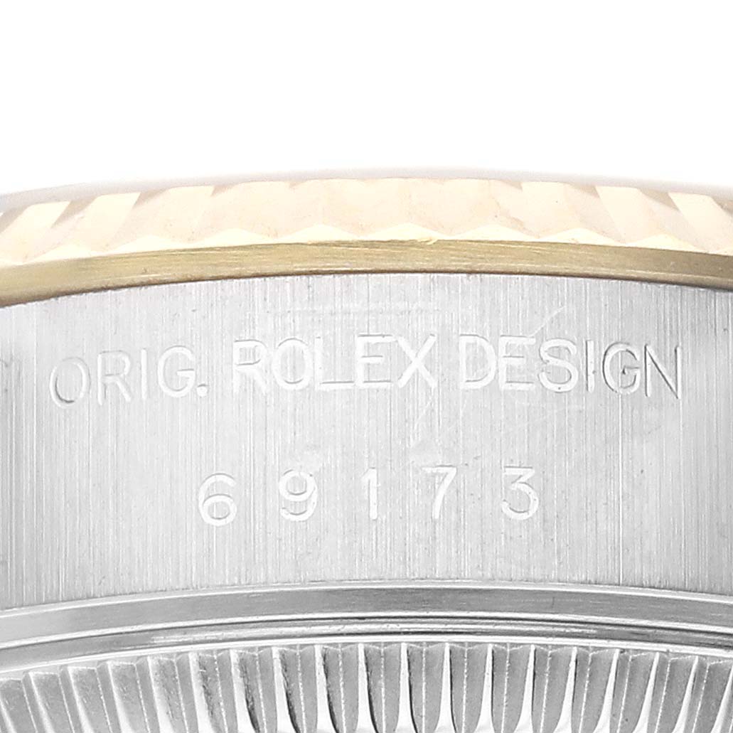 This close-up image of a Rolex Datejust 69173 Women's Steel and Gold (two tone) Champagne Dial 69173 Women's Steel and Gold (two tone) Champagne Dial watch shows its case side with the engraved text "ORIG. ROLEX DESIGN" and the reference number "69173".