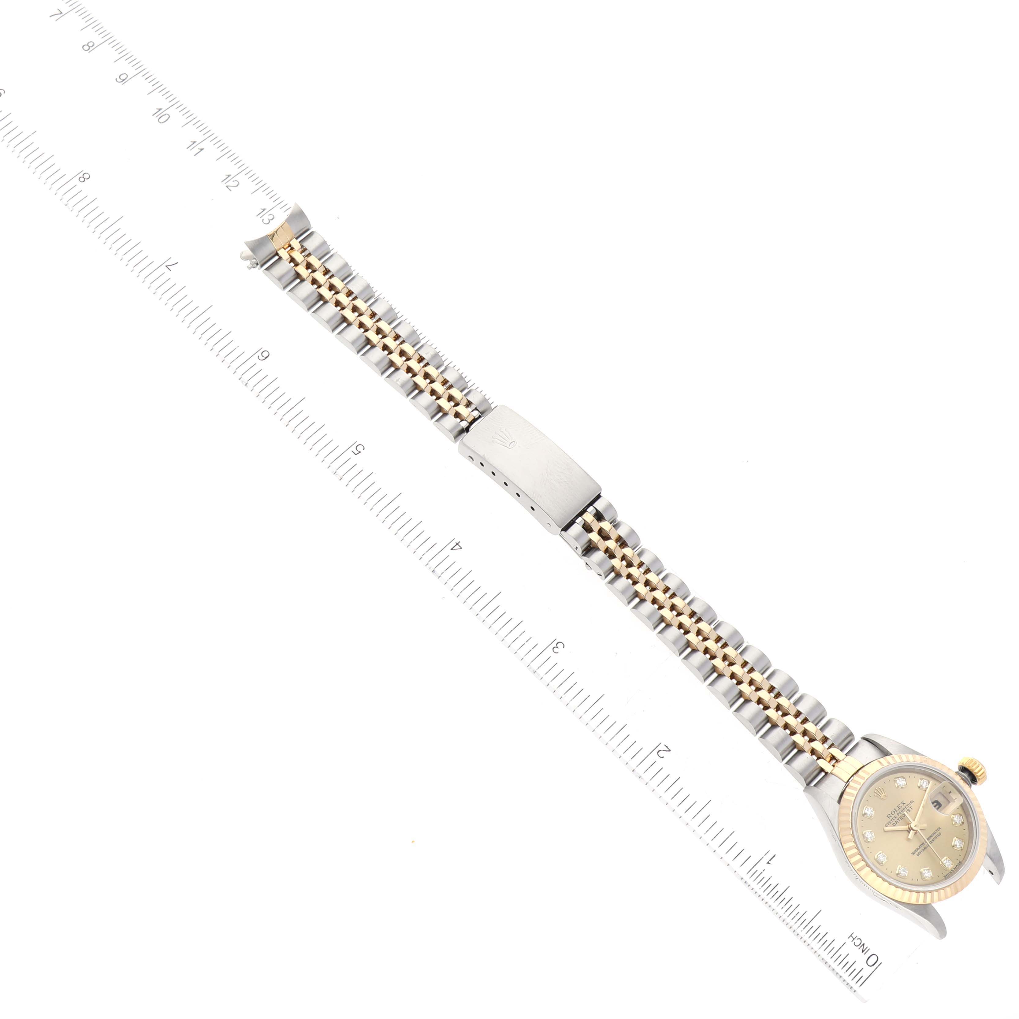 The image shows a Rolex Datejust 69173 Women's Steel and Gold (two tone) Champagne Dial 69173 Women's Steel and Gold (two tone) Champagne Dial watch in a vertical angle, featuring the dial, crown, and full bracelet.