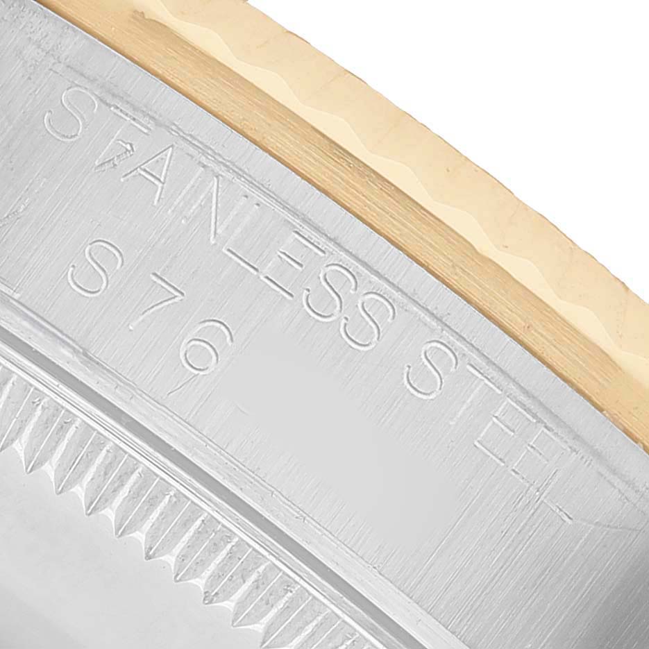 The image shows a close-up of the stainless steel case back edge of a Rolex Mid-Size 68273 Women's Steel and Gold (two tone) Champagne Dial watch.