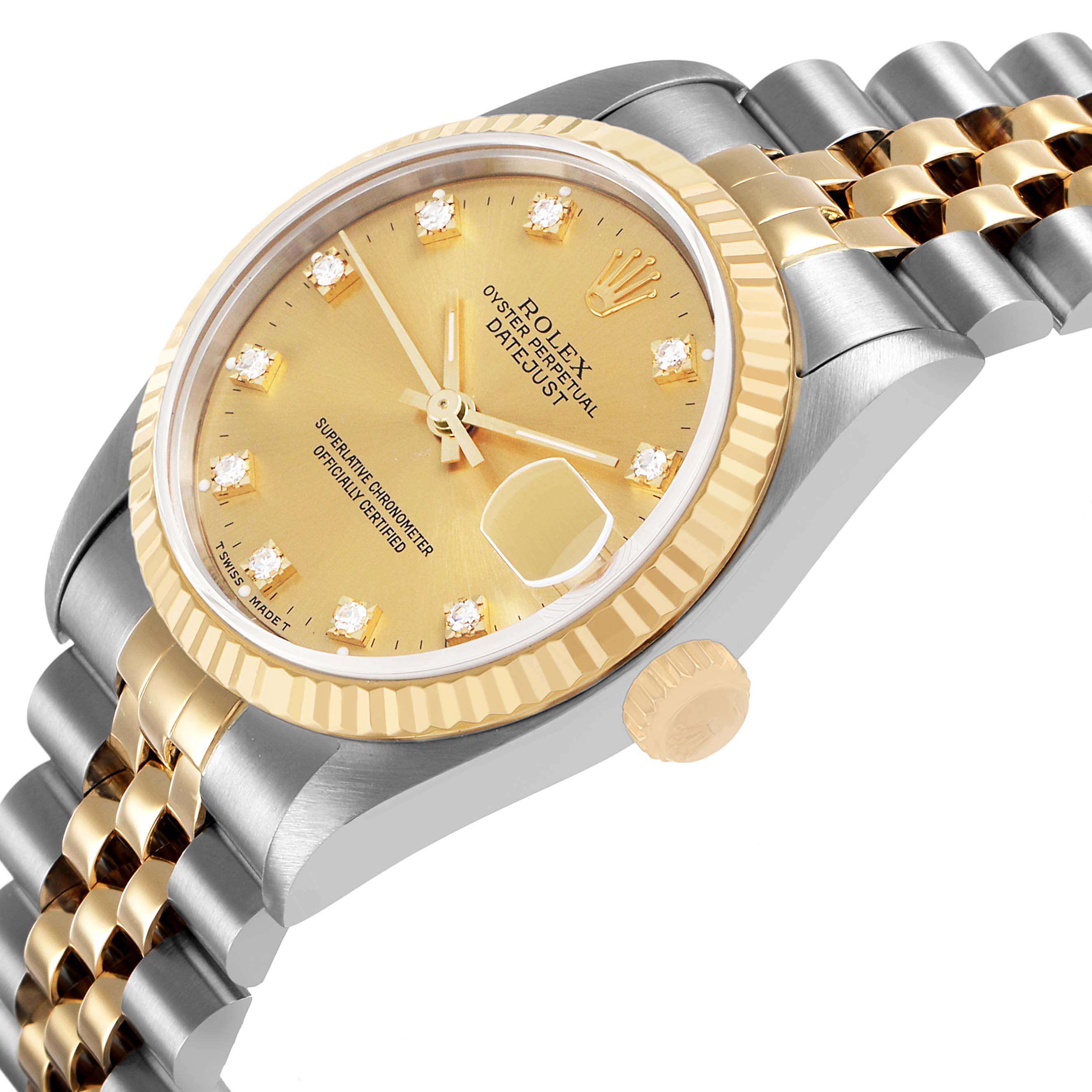 The Rolex Mid-Size 68273 Women's Steel and Gold (two tone) Champagne Dial watch is shown at an angled side view, displaying its fluted bezel, crown, and jubilee bracelet.