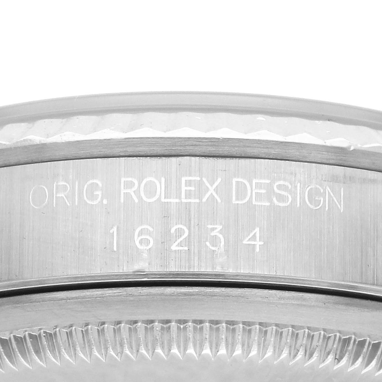 The image shows a close-up of the side of a Rolex Datejust 16234 Men's Stainless Steel Mother of Pearl Dial 16234 Men's Stainless Steel Mother of Pearl Dial watch, featuring engraved design details and part of the bezel.