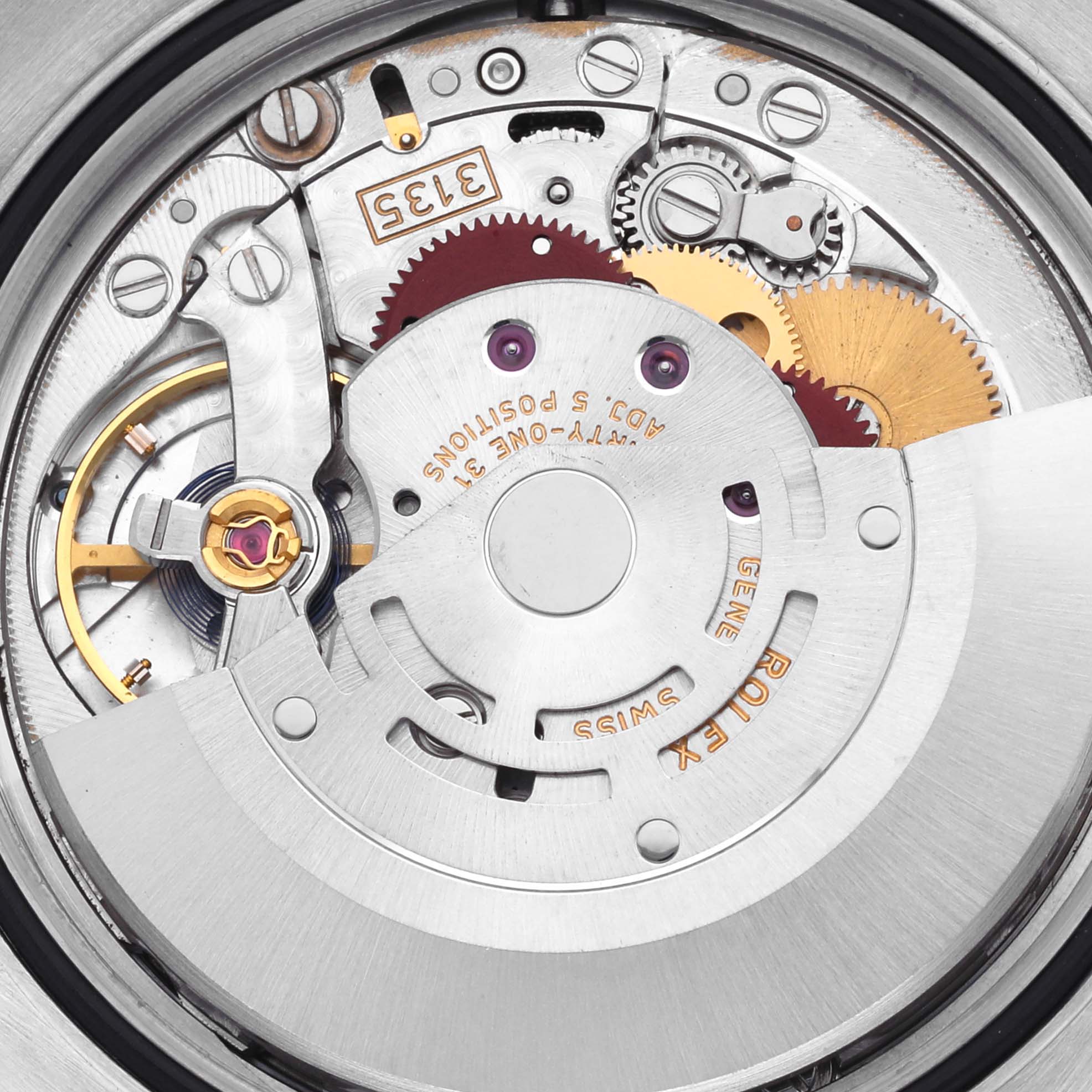 The image shows the inner movement of a Rolex Datejust 116200 Men's Stainless Steel Silver Dial 116200 Men's Stainless Steel Silver Dial watch, highlighting its gears and rotor mechanism.