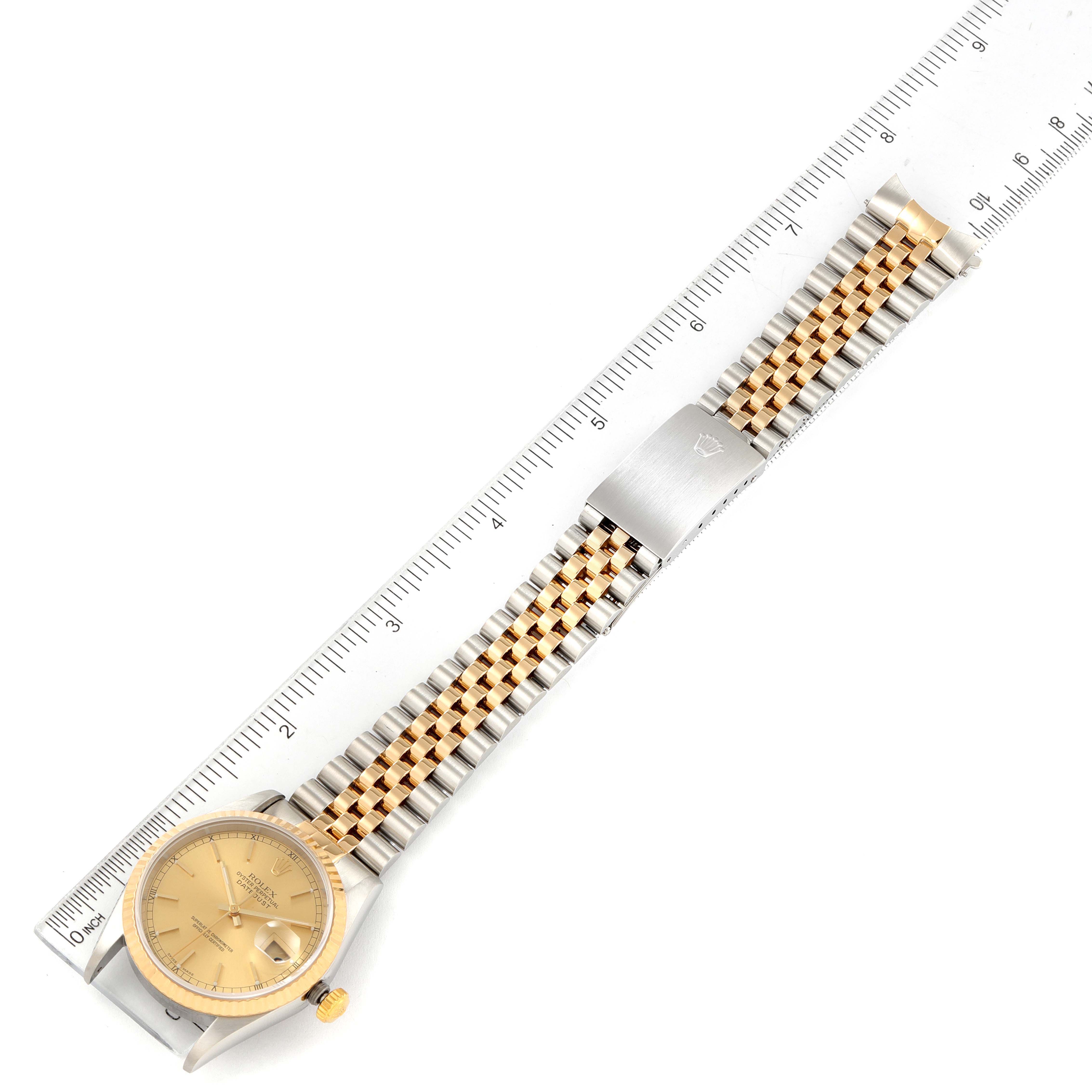 The image shows a top-down view of a Rolex Datejust 16233 Men's Steel and Gold (two tone) Champagne Dial 16233 Men's Steel and Gold (two tone) Champagne Dial watch, including the dial, case, and metal bracelet with a ruler for scale.