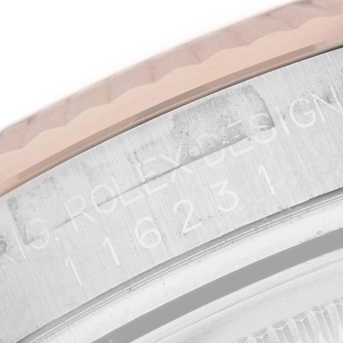 This close-up image shows the engraved reference number on the side of a Rolex Datejust 116231G Men's Steel and Gold (two tone) Pink Dial 116231G Men's Steel and Gold (two tone) Pink Dial watch case.