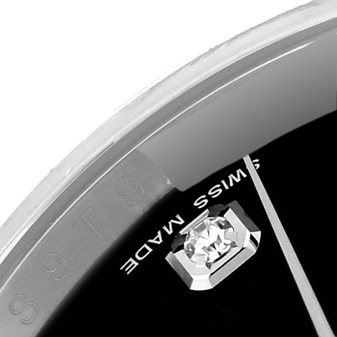 This close-up image of a Rolex Datejust 116234 Men's Stainless Steel Black Dial 116234 Men's Stainless Steel Black Dial watch shows the dial with a diamond marker and part of the bezel.