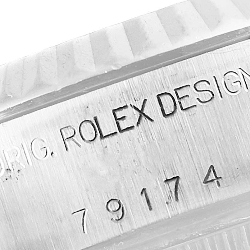 This image shows a close-up of the Rolex Datejust 79174 Women's Stainless Steel Silver Dial 79174 Women's Stainless Steel Silver Dial model's case side, highlighting the engraved model number and "Rolex Design."