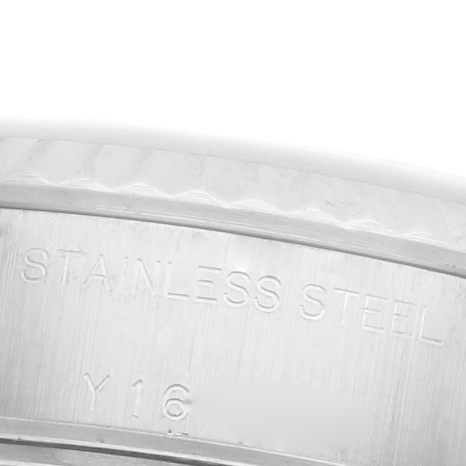 The image shows a close-up of the Rolex Datejust 79174 Women's Stainless Steel Pink Dial 79174 Women's Stainless Steel Pink Dial's stainless steel case side with engraved text.