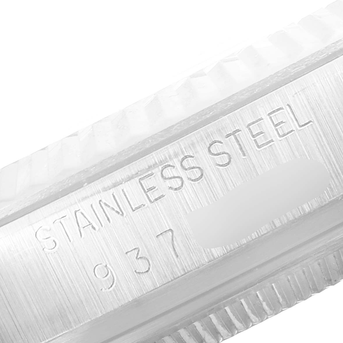 This close-up angle shows the "Stainless Steel" engraving on the bezel of the Rolex Vintage Collection 16014 Men's Stainless Steel Silver Dial 16014 Men's Stainless Steel Silver Dial model.