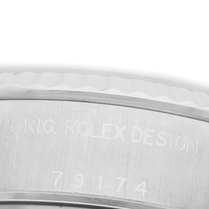 The image shows a close-up of the engraving on the side of a Rolex Datejust 79174 Women's Stainless Steel Silver Dial 79174 Women's Stainless Steel Silver Dial watch case.