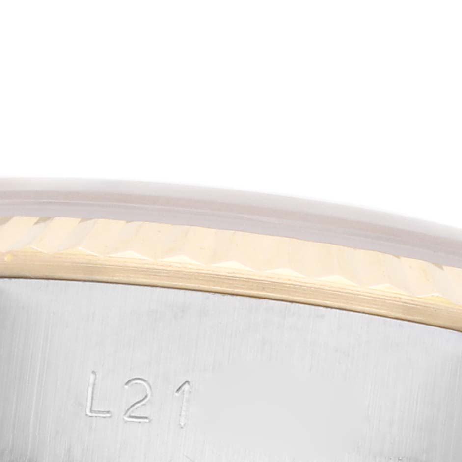 The image shows a close-up of the side of a Rolex Datejust 69173 Women's Steel and Gold (two tone) Champagne Dial 69173 Women's Steel and Gold (two tone) Champagne Dial bezel, highlighting its fluted edge and part of the case with markings.