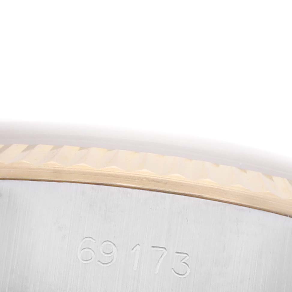 The image shows a close-up of the model number engraving and the fluted bezel on a Rolex Datejust 69173 Women's Steel and Gold (two tone) Champagne Dial 69173 Women's Steel and Gold (two tone) Champagne Dial watch.