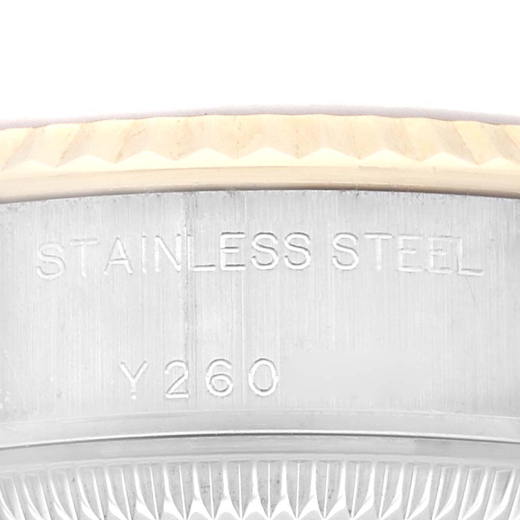 This image shows a close-up of the Datejust model Rolex's stainless steel case with engraved lettering.