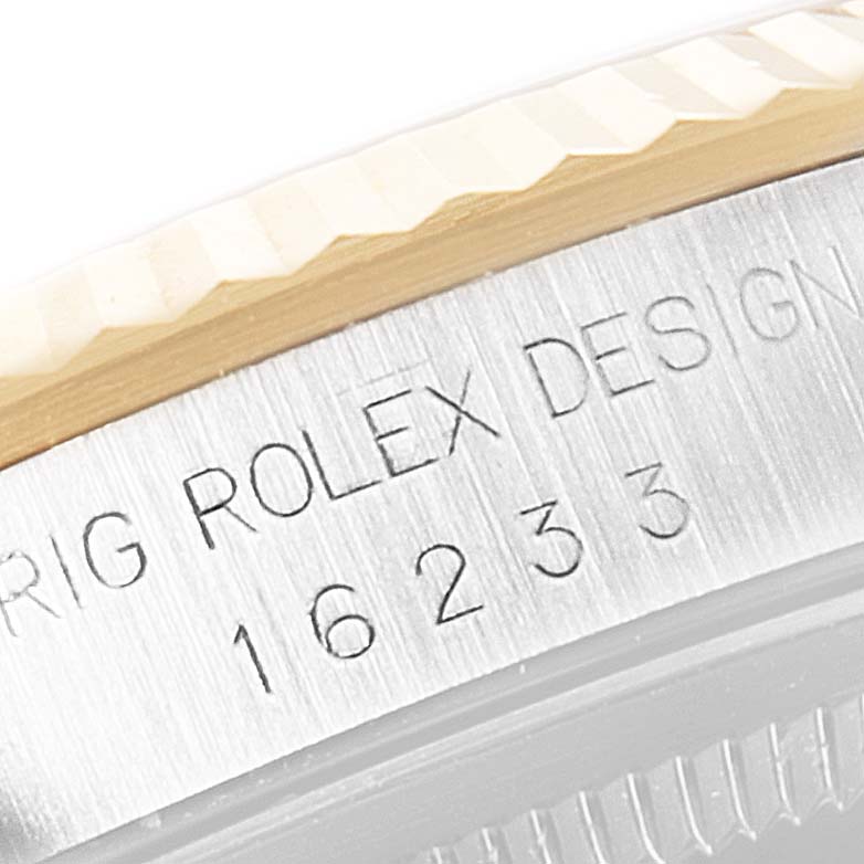 The image shows a close-up of the model number and branding etched into the side of a Rolex Datejust 16233 Men's Steel and Gold (two tone) Champagne Dial 16233 Men's Steel and Gold (two tone) Champagne Dial watch bezel and case.