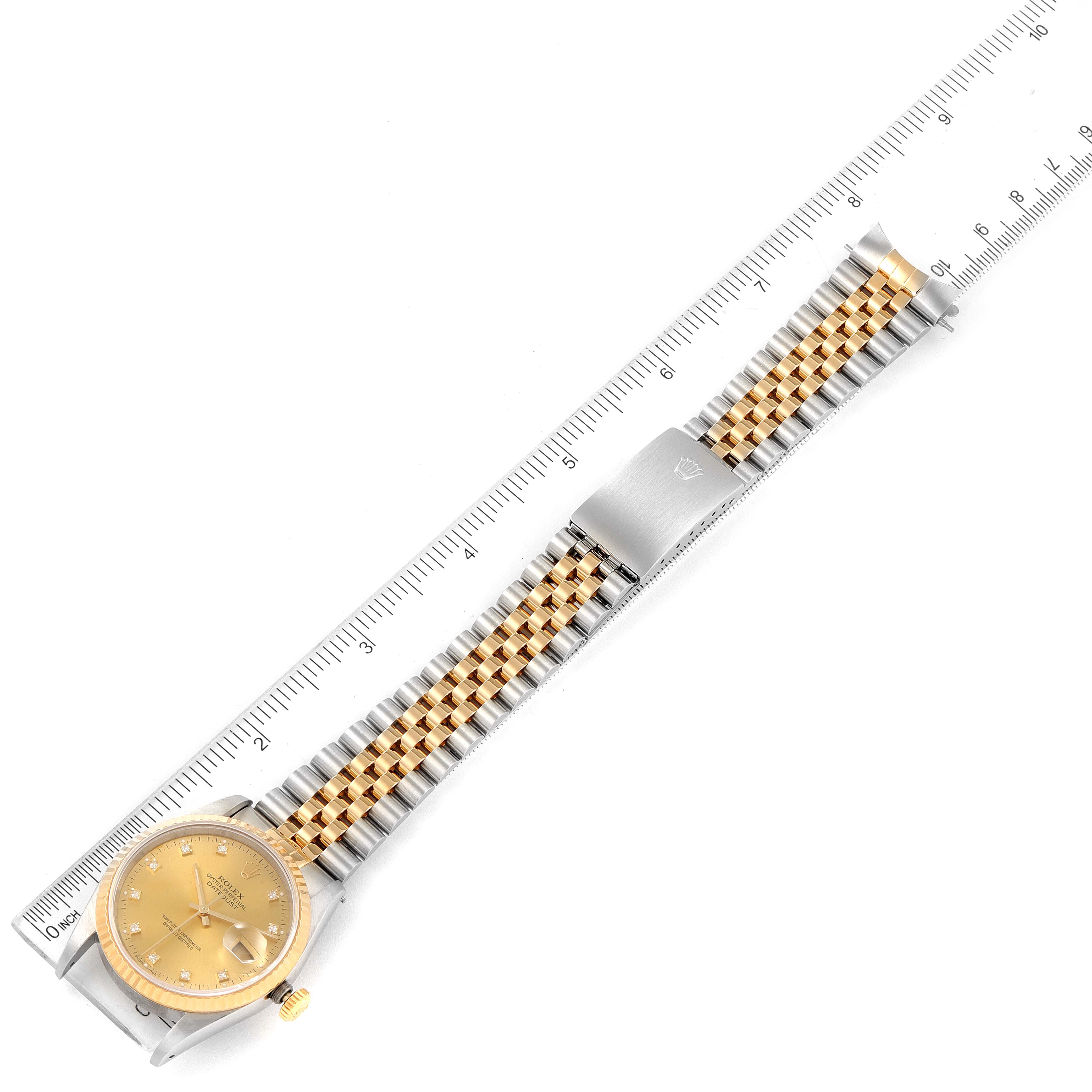 This image shows a top view of a Rolex Datejust 16233 Men's Steel and Gold (two tone) Champagne Dial 16233 Men's Steel and Gold (two tone) Champagne Dial model watch with its gold and silver jubilee bracelet alongside a ruler.