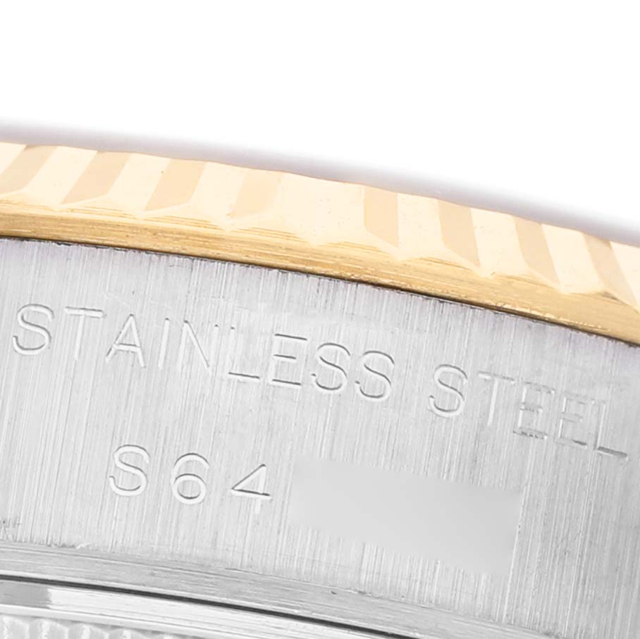 The image shows a close-up of the side of a Rolex Datejust 69173 Women's Steel and Gold (two tone) Champagne Dial, highlighting the fluted bezel and "Stainless Steel" engraving.