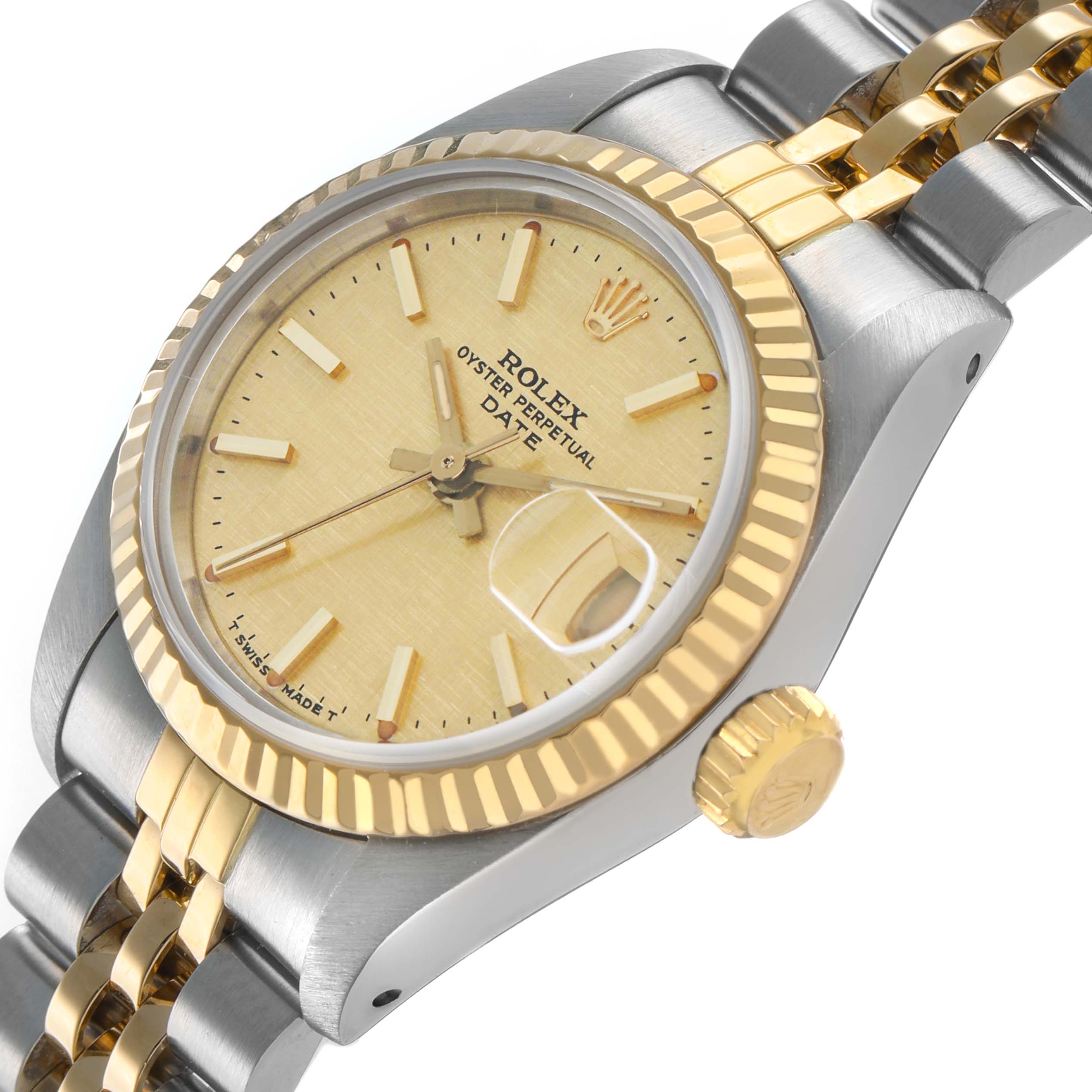 The Rolex Datejust 69173 Women's Steel and Gold (two tone) Champagne Dial watch is shown at a close side angle, highlighting the gold bezel, crown, and part of the bracelet.