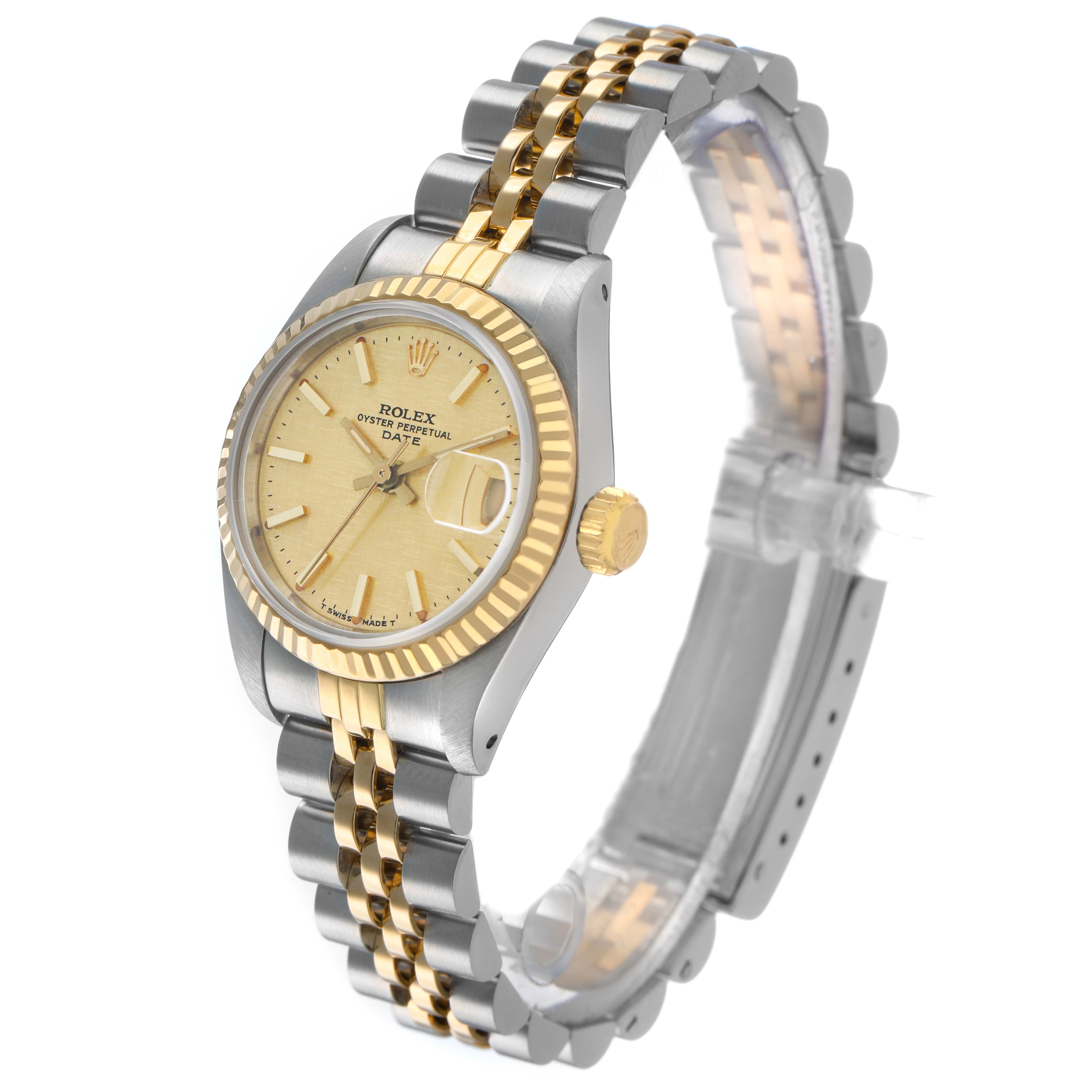 The Rolex Datejust 69173 Women's Steel and Gold (two tone) Champagne Dial watch is shown at a three-quarter angle, highlighting the gold fluted bezel, dial, and two-tone bracelet.