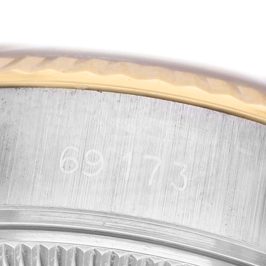 The image shows a close-up of the side edge of a Rolex Datejust 69173 Women's Steel and Gold (two tone) Champagne Dial watch, highlighting the reference number and part of the bezel.