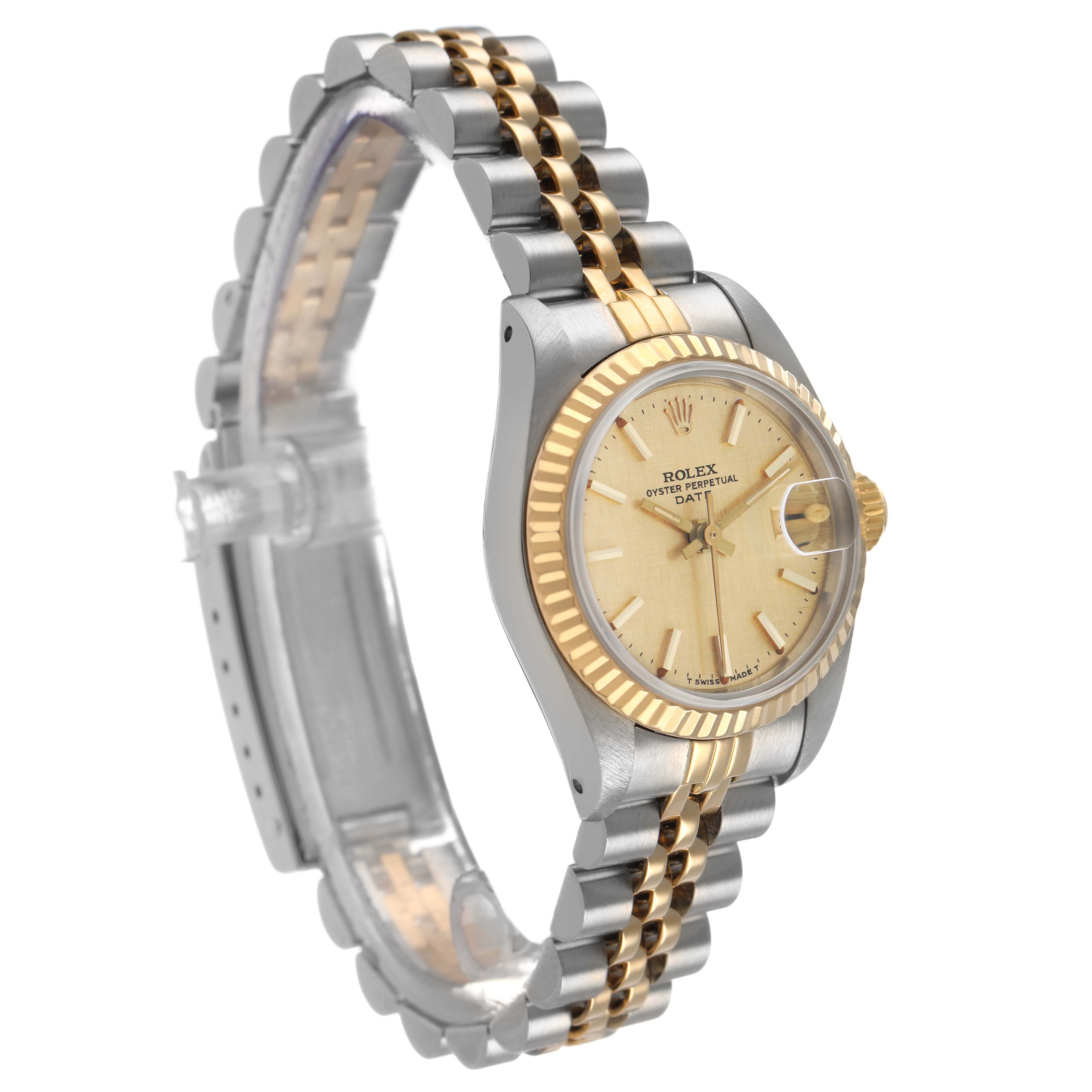 The Rolex Datejust 69173 Women's Steel and Gold (two tone) Champagne Dial watch is shown at a side angle, highlighting its bezel, face, and jubilee bracelet.