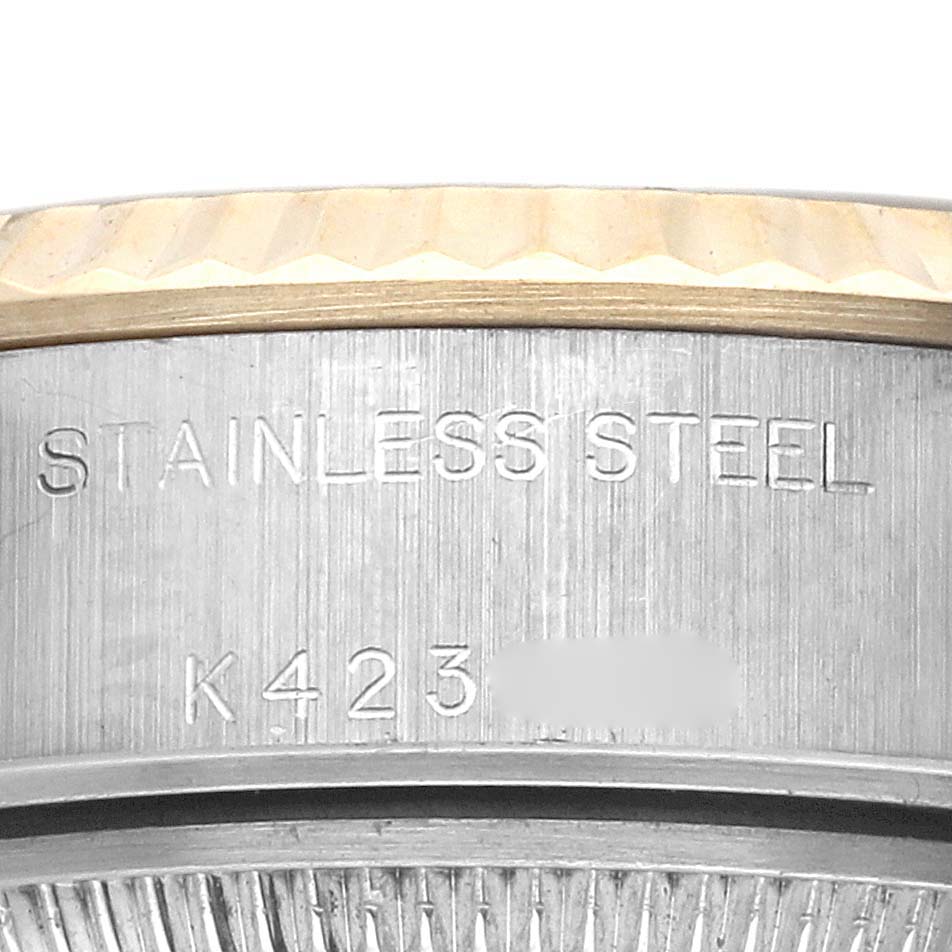 This image shows a close-up of the side of a Rolex Datejust 79173 Women's Steel and Gold (two tone) Champagne Dial 79173 Women's Steel and Gold (two tone) Champagne Dial watch, highlighting the "Stainless Steel" engraving and reference number.