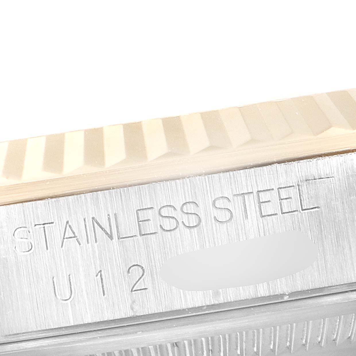 This close-up image shows the stainless steel side with engraving details of a Rolex Datejust 16233 Men's Steel and Gold (two tone) Silver Dial 16233 Men's Steel and Gold (two tone) Silver Dial watch bezel.