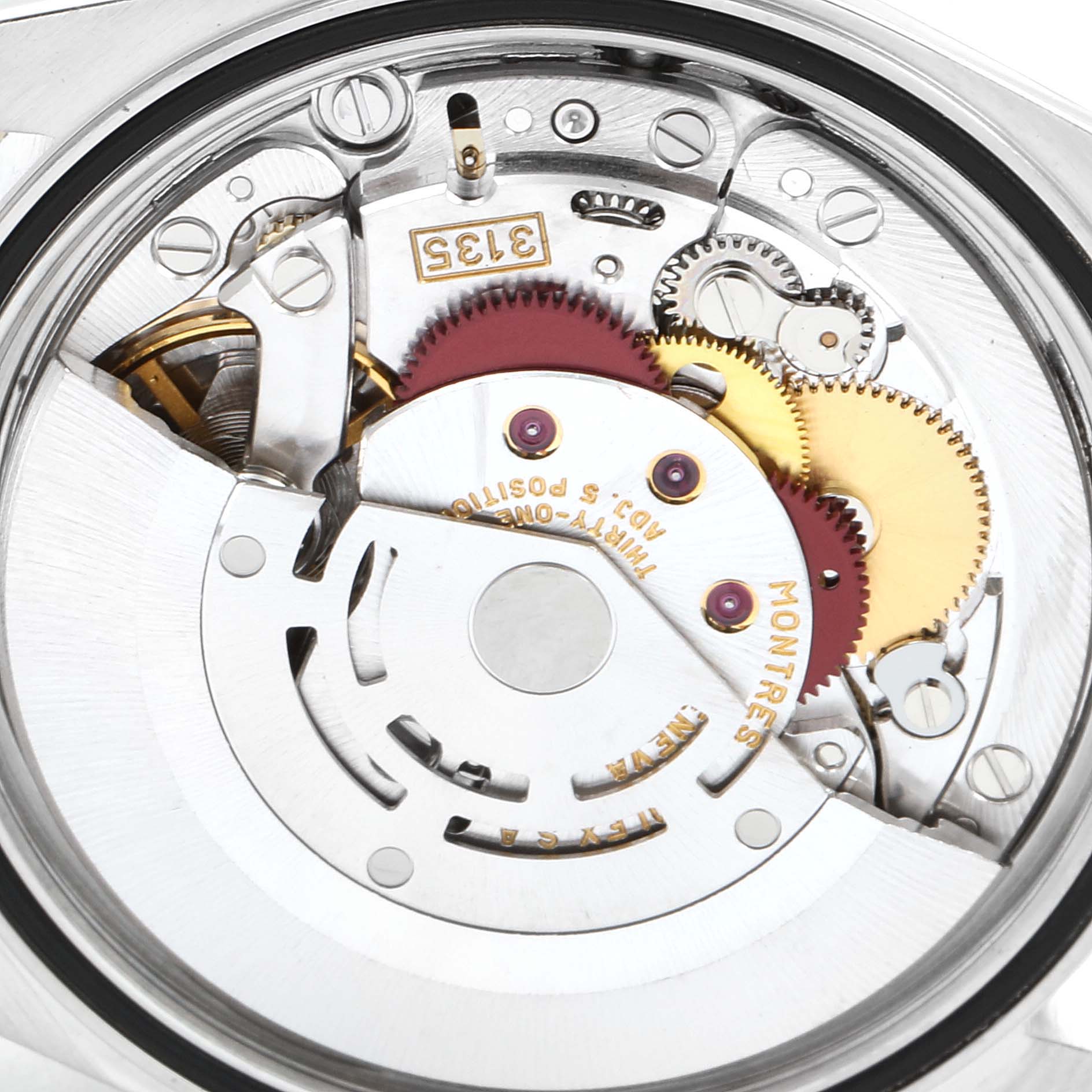 The image shows an internal view of the Rolex Datejust 16233 Men's Steel and Gold (two tone) Silver Dial 16233 Men's Steel and Gold (two tone) Silver Dial watch movement, including gears and intricate mechanical components.