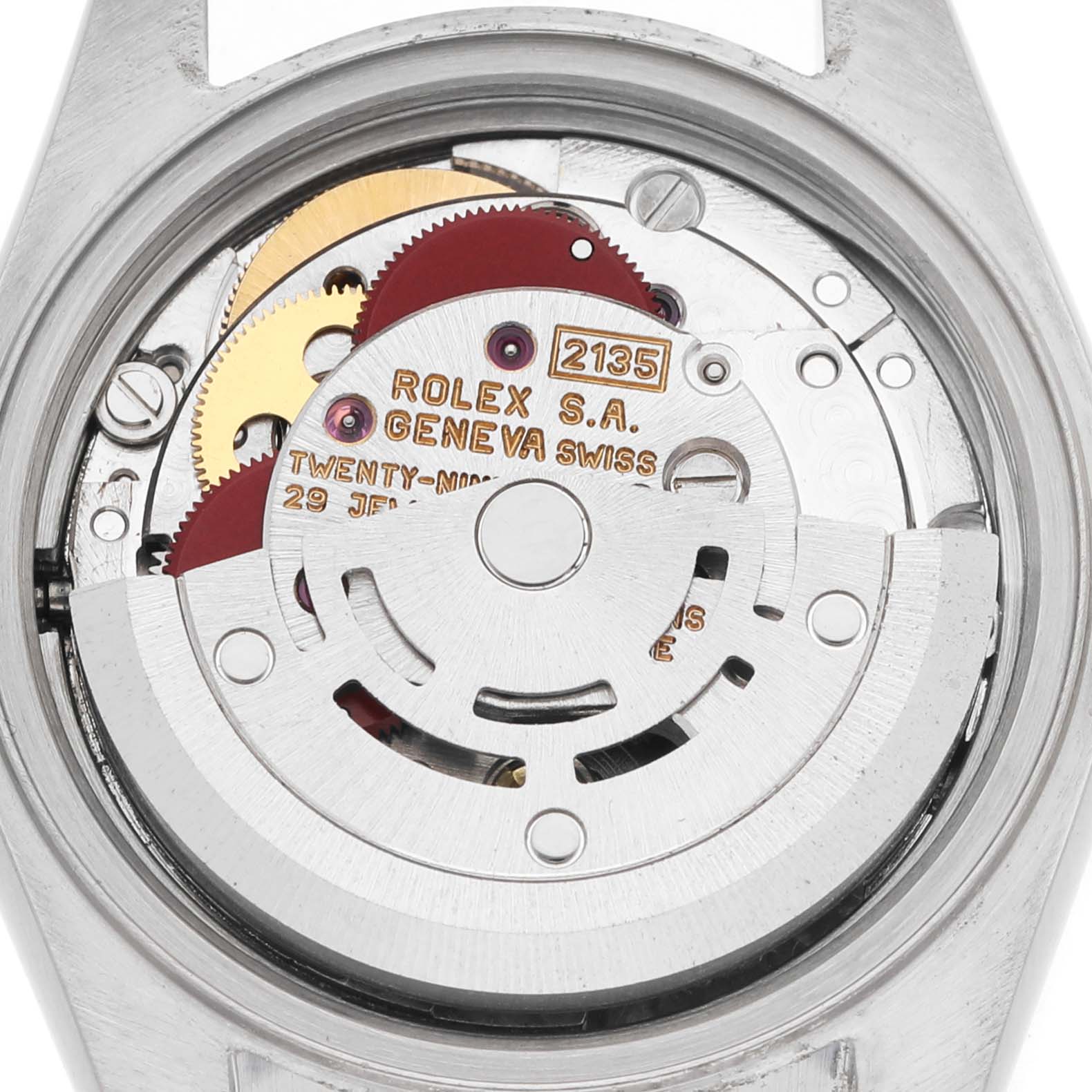 This image shows a close-up of the movement of a Rolex Datejust 69173 Women's Steel and Gold (two tone) White Dial watch, displaying its intricate gears and inscriptions.