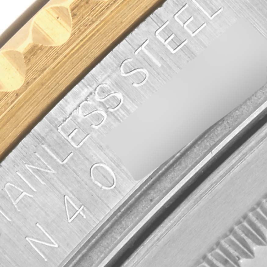 The image shows a close-up of the side of a Rolex GMT-Master 16713LN Men's Steel and Gold (two tone) Black Dial 16713LN Men's Steel and Gold (two tone) Black Dial, featuring the metal and possibly the bezel and case.