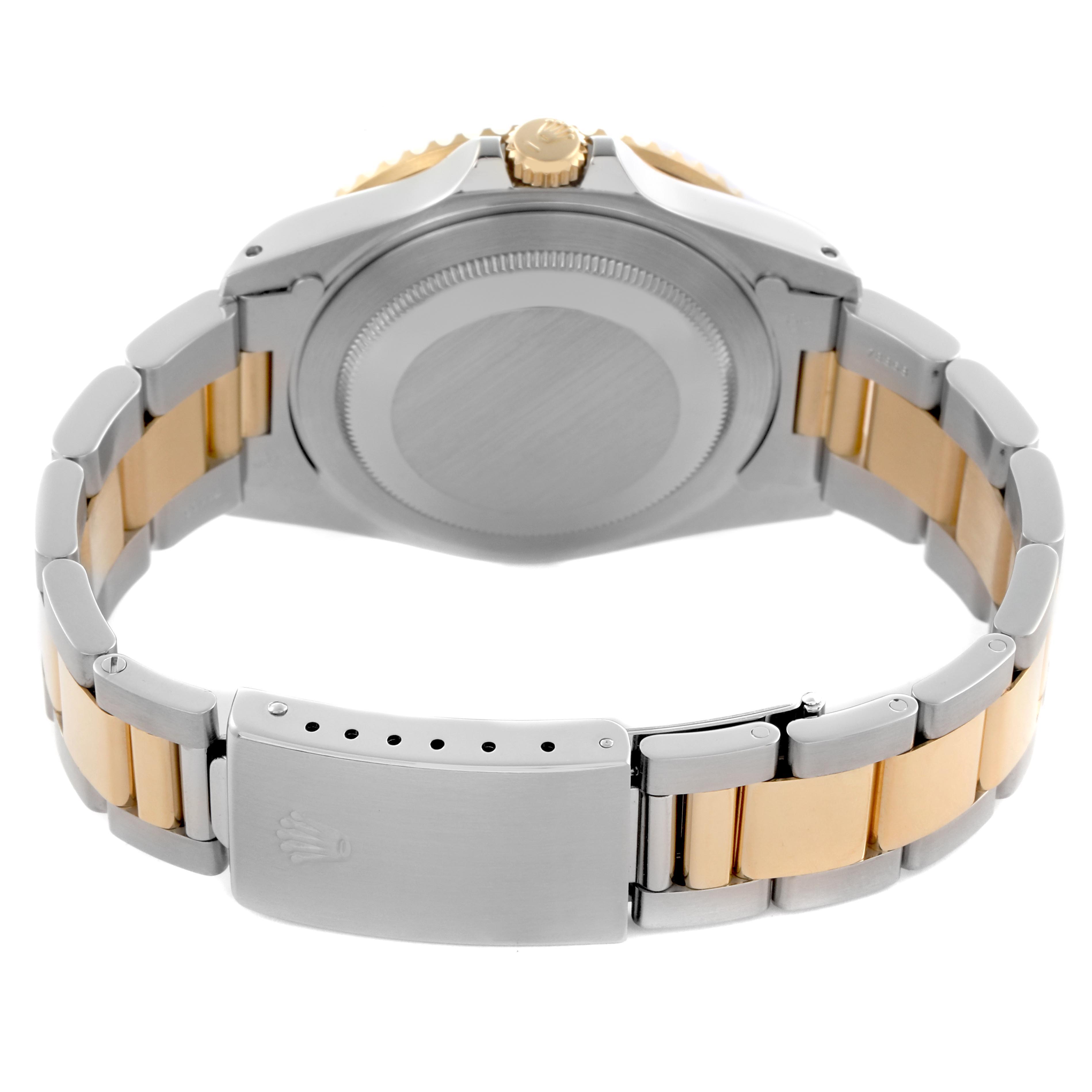 The Rolex GMT-Master 16713LN Men
s Steel and Gold (two tone) Black Dial 16713LN Men
s Steel and Gold (two tone) Black Dial watch is shown from the back, highlighting its case, crown, and stainless steel and gold bracelet.